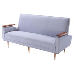 Vintage A restored sofa with floating wood arms and metal mounts circa 1960.