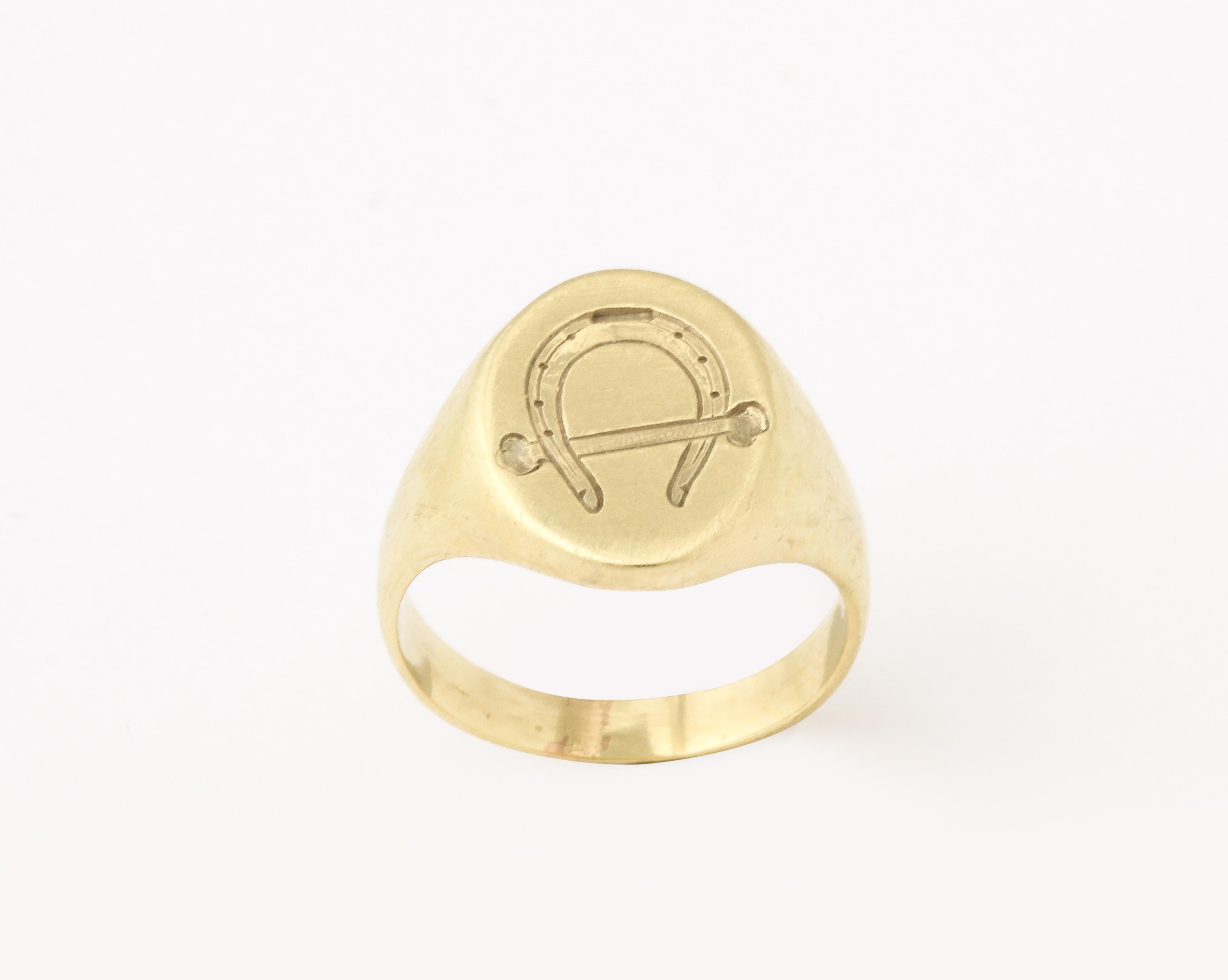 This is a lovable equestrian lover signet ring engraved with a horseshoe and a riding crop. It is a pinky ring , size 5  can be worn on the ring finger or but can be enlarged if wished. The engraving is crisp. The face measures 13.2mmx11mm. Wear it