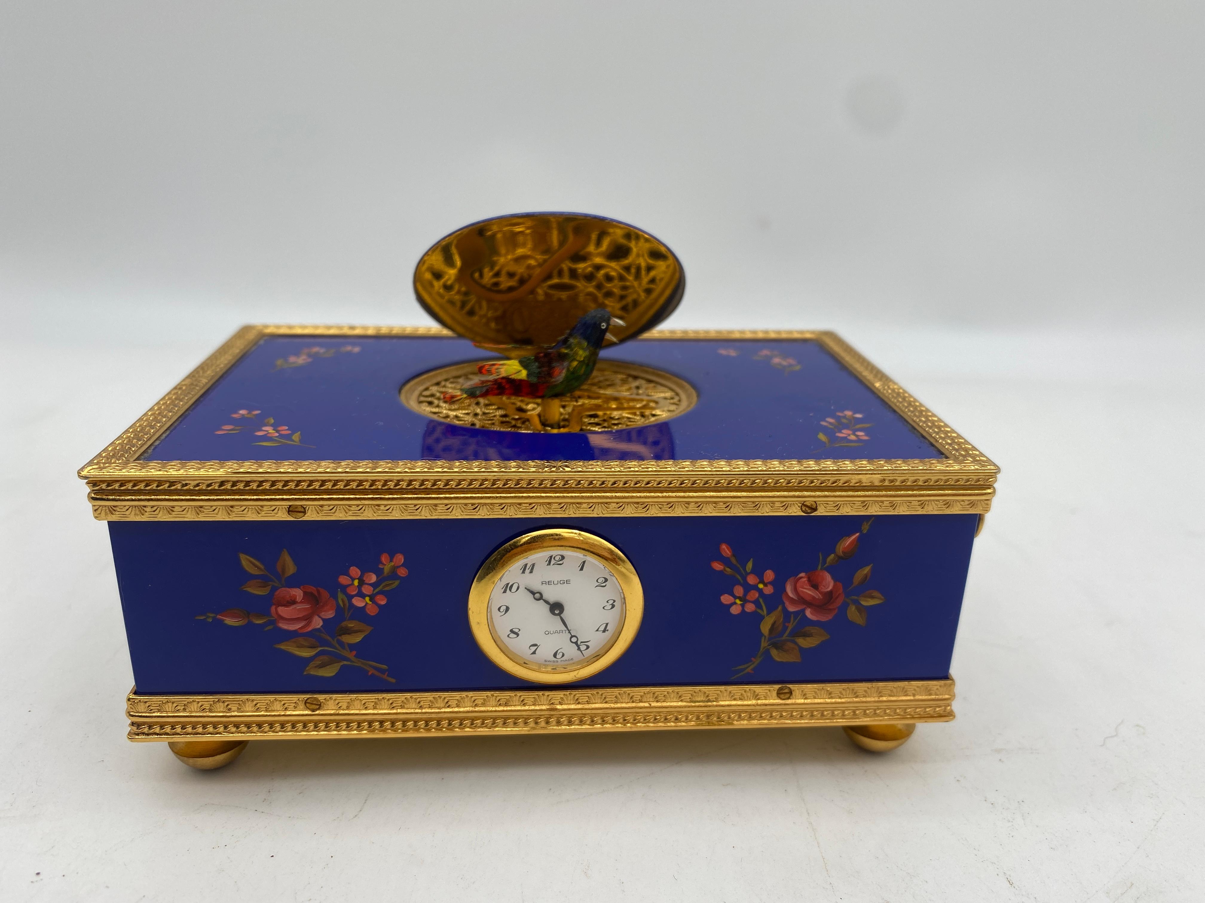 A reuge enameled music Box with Bird automaton and clock , The box with blue enamel exterior embellished with flowers and singing bird as shown in good working order. made in Switzerland
Measures 2 x 4.75 x 3.25 ''
Good working condition ,