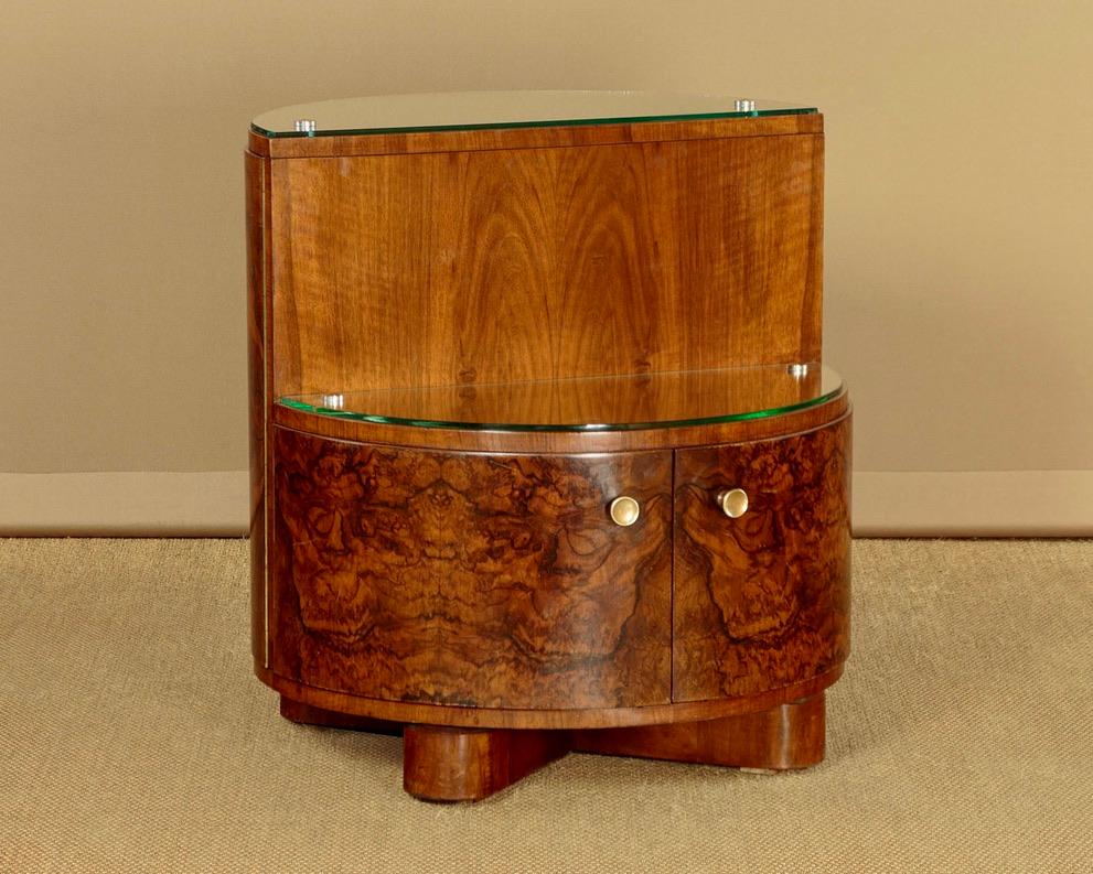 A Beautiful Art Deco revolving cylinder drinks or cocktail cabinet crafted from walnut circa 1930. This unique piece features a cylindrical design divided into two sections, each with toughened glass tops accented by chrome fittings. The bow fronted