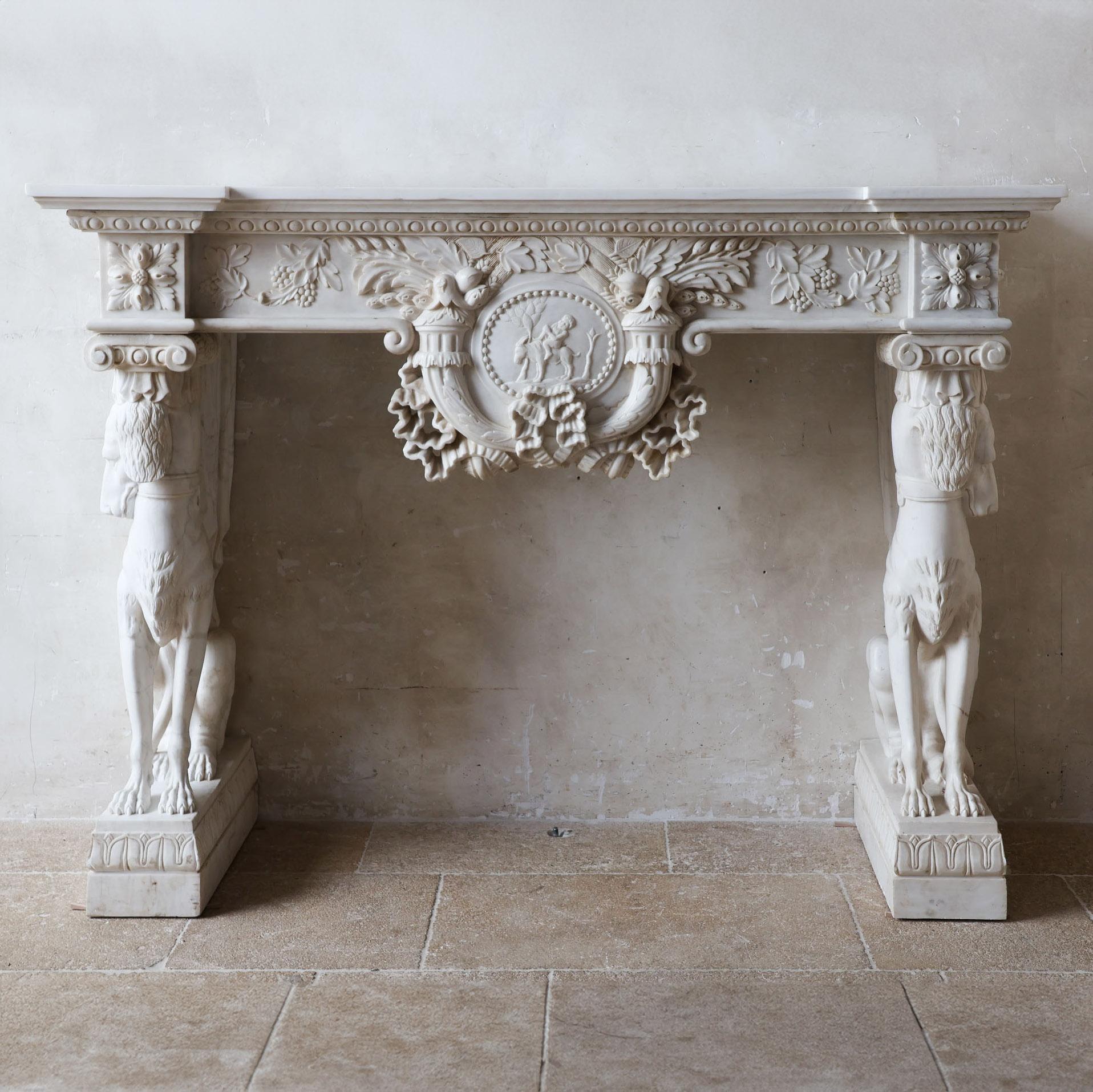 A rich and ornate monumental mantelpiece in the Italian Renaissance Revival style. Executed in the most exclusive selection of white marble from Carrara, the statuario quality, characterized by its pristine appearance without veins. The entire
