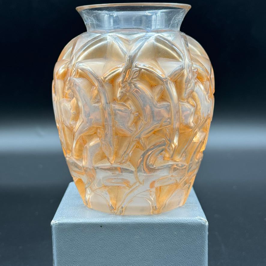 The Chamois vase is an Art Deco vase designed in 1931 by R.Lalique in white glass.

This example is in excellent condition and is patinated in brown.

The vase is signed in sand blasted block letters .