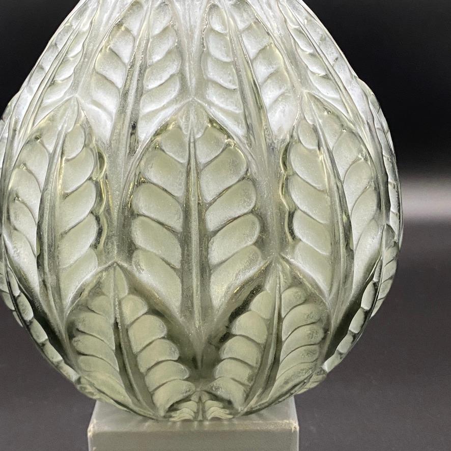 The Malesherbes vase was created in 1927 by R.Lalique in white glass .

This example is in deep grey glass with a strong white patina and a hand written signature .

The design of the Malesherbes vase belongs to the Art Deco period and represents