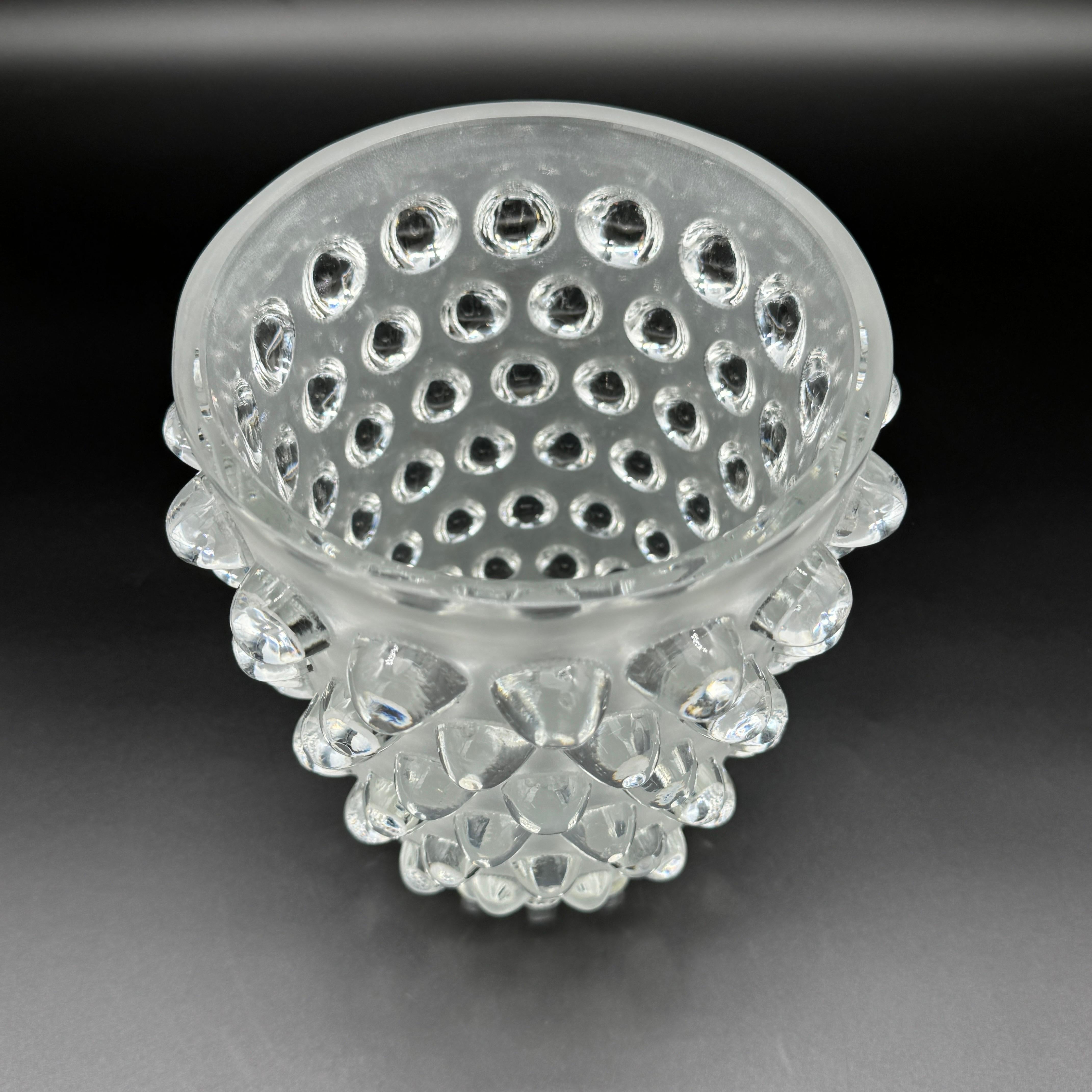The Mossi vase was created by R.Lalique in 1933 in white glass .
It is a strong Art Deco design with a sand blasted frosting finish of excellent quality.
The dots are polished and transparent .
The vase catches the light perfectly and is signed