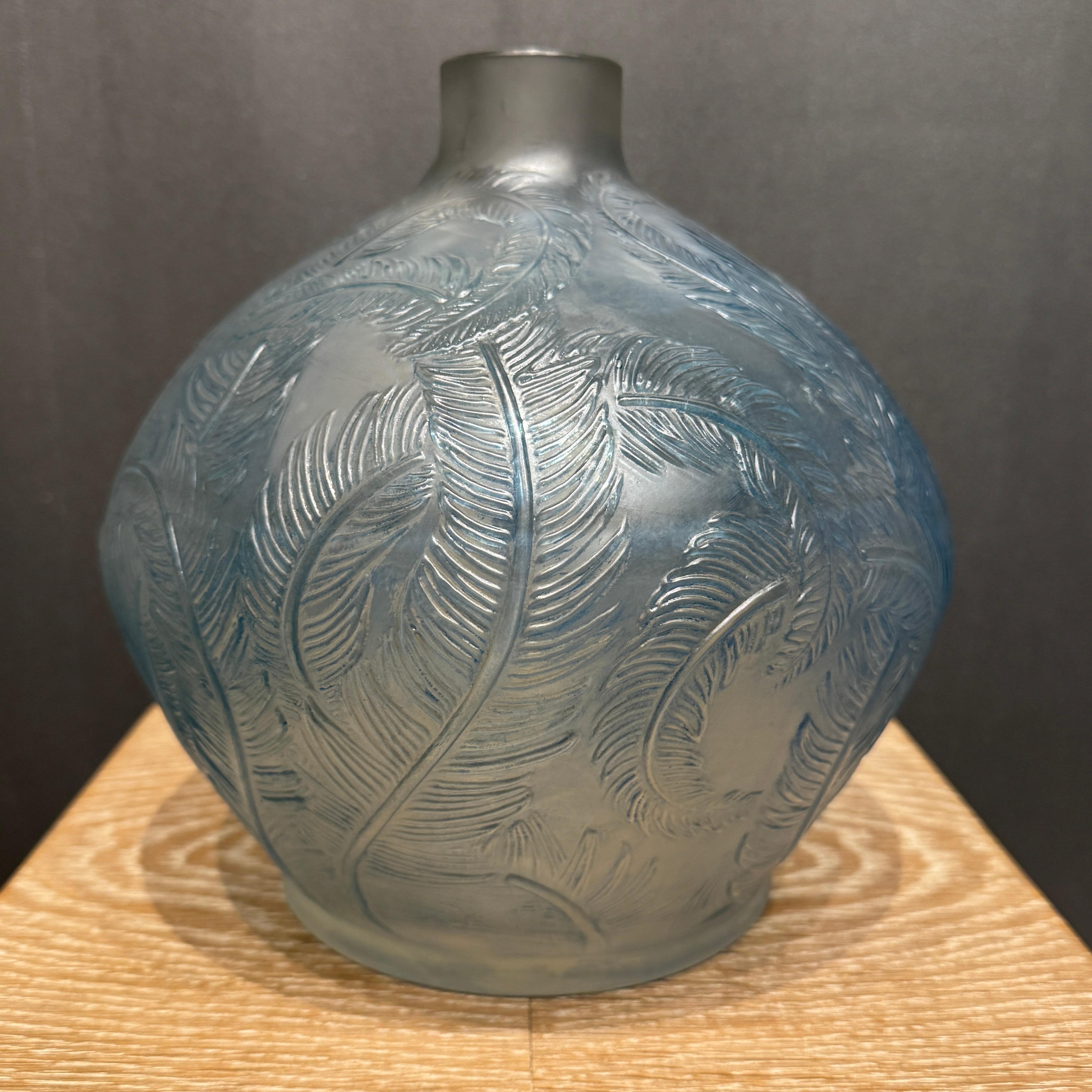 A Strong and early large Art Déco vase by R.Lalique in white and blue patinated glass.

The vase is signed twice in molded block letters and by hand in cursive letters.