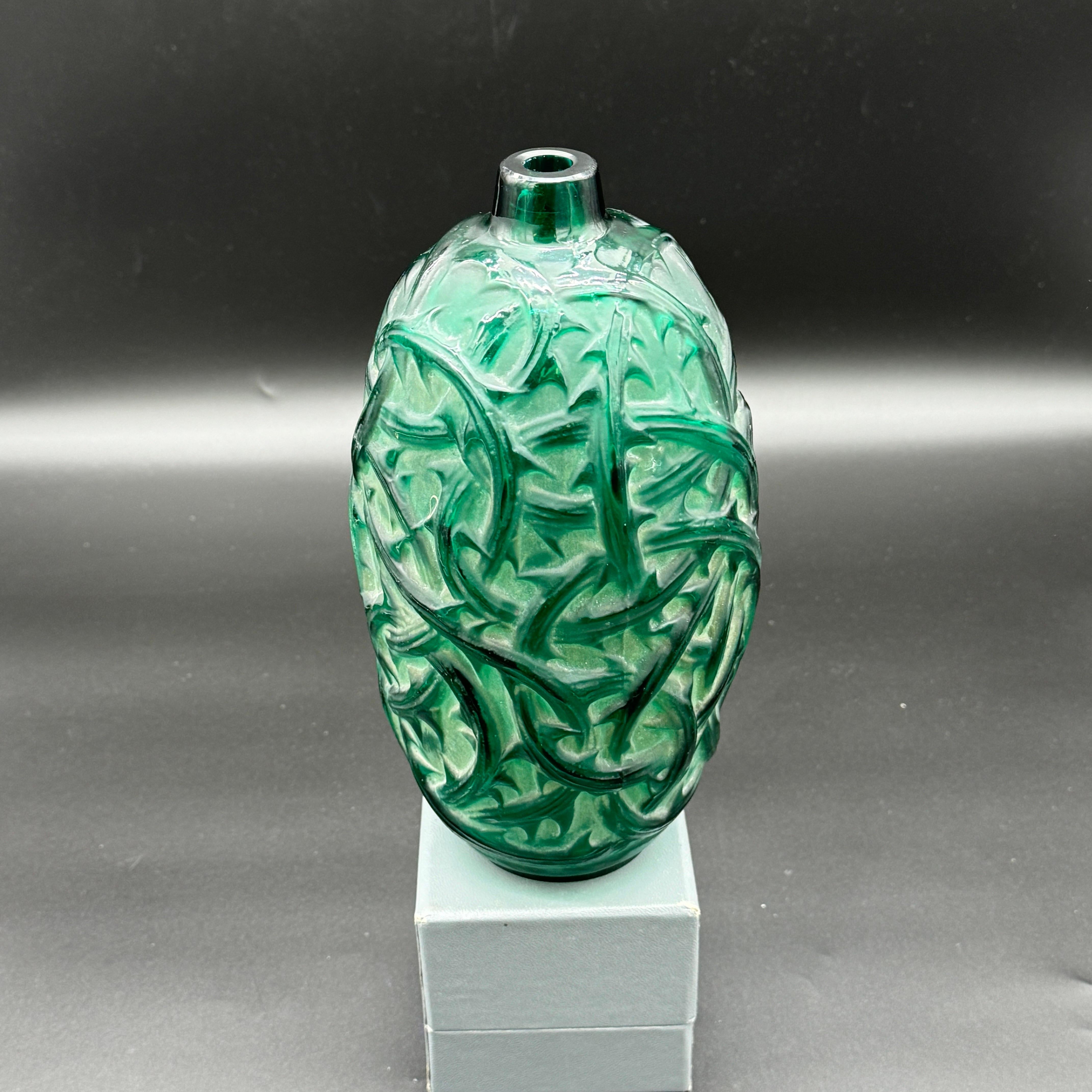 The Ronces vase was made in 1921 in white glass by R.Lalique.
This example is in deep green glass with a white patina .

The vase is in excellent condition and signed in molded block letters as well as in handwritten script letters .

The vase