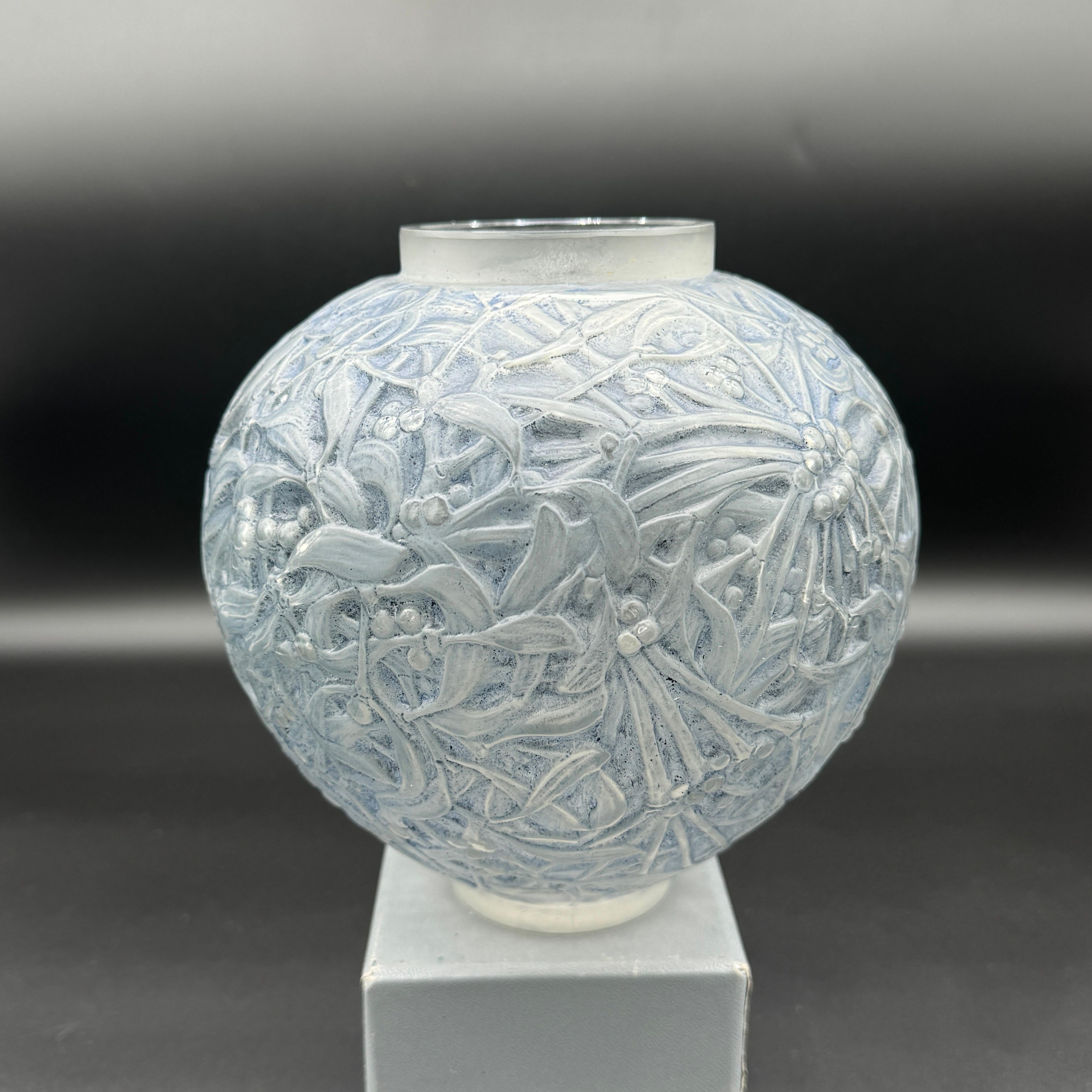 The  Gui vase was created by R.Lalique in 1920 in white glass.

This vase is in white glass with a blue patina .

The signature is hand written in script letters .

The vase is in excellent condition.

The vase is 18 cm high and 14 cm wide .