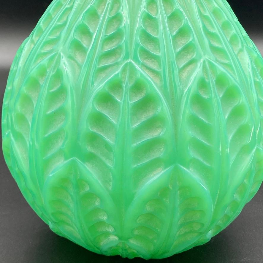 The Malesherbes vase by R.Lalique has a strong Art Deco style .

The stylized leaves have received a white patina to stand out on the jade colored glass.

Jade glass is one of the most collectible colors R.Lalique has produced .

Colored glass was