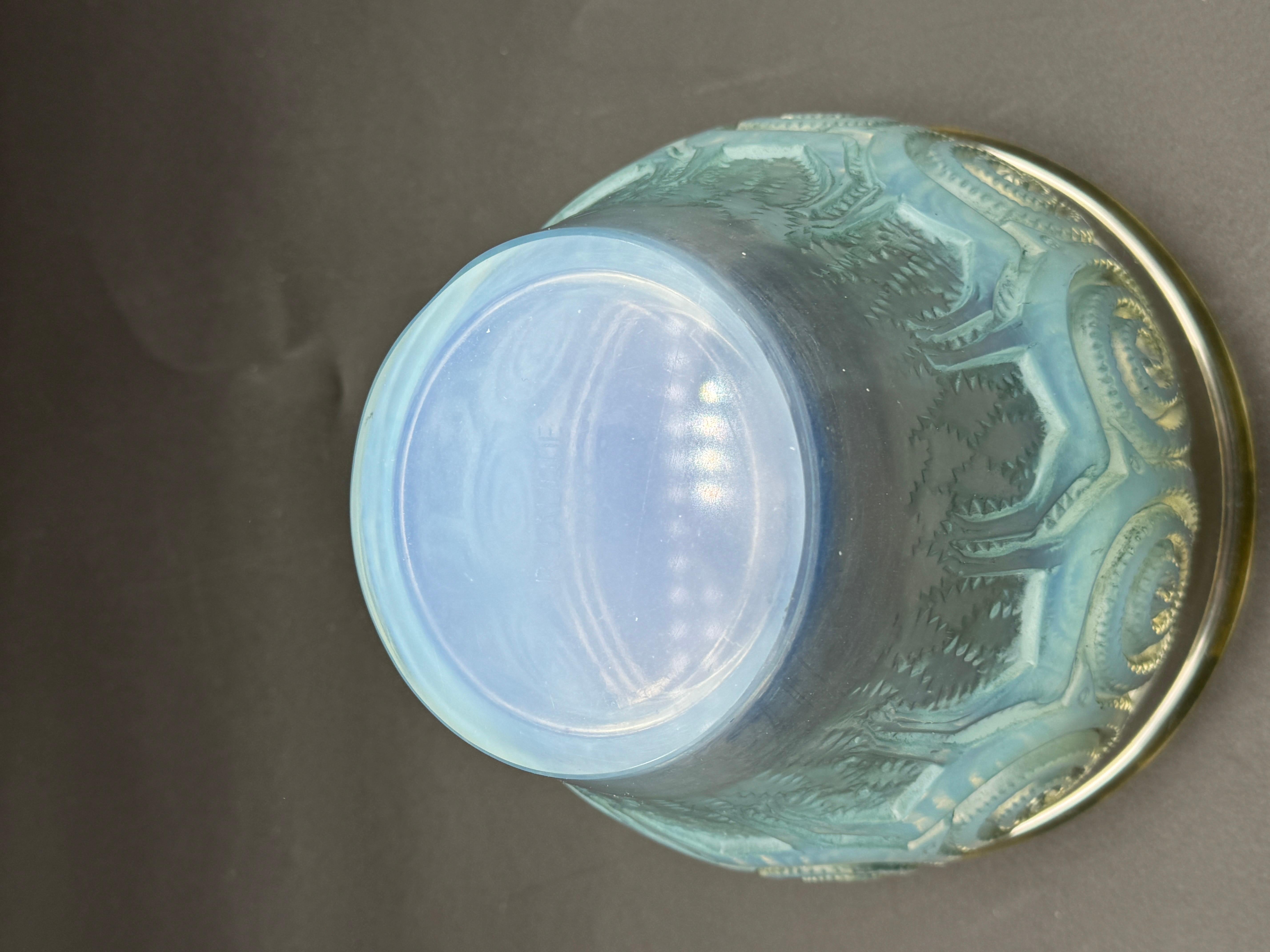 the Rennes vase was created by R.Lalique in 1933 in white glass.

This piece is in strong opalescent glass and in excellent condition .

The vase is signed in sand blasted block letters.