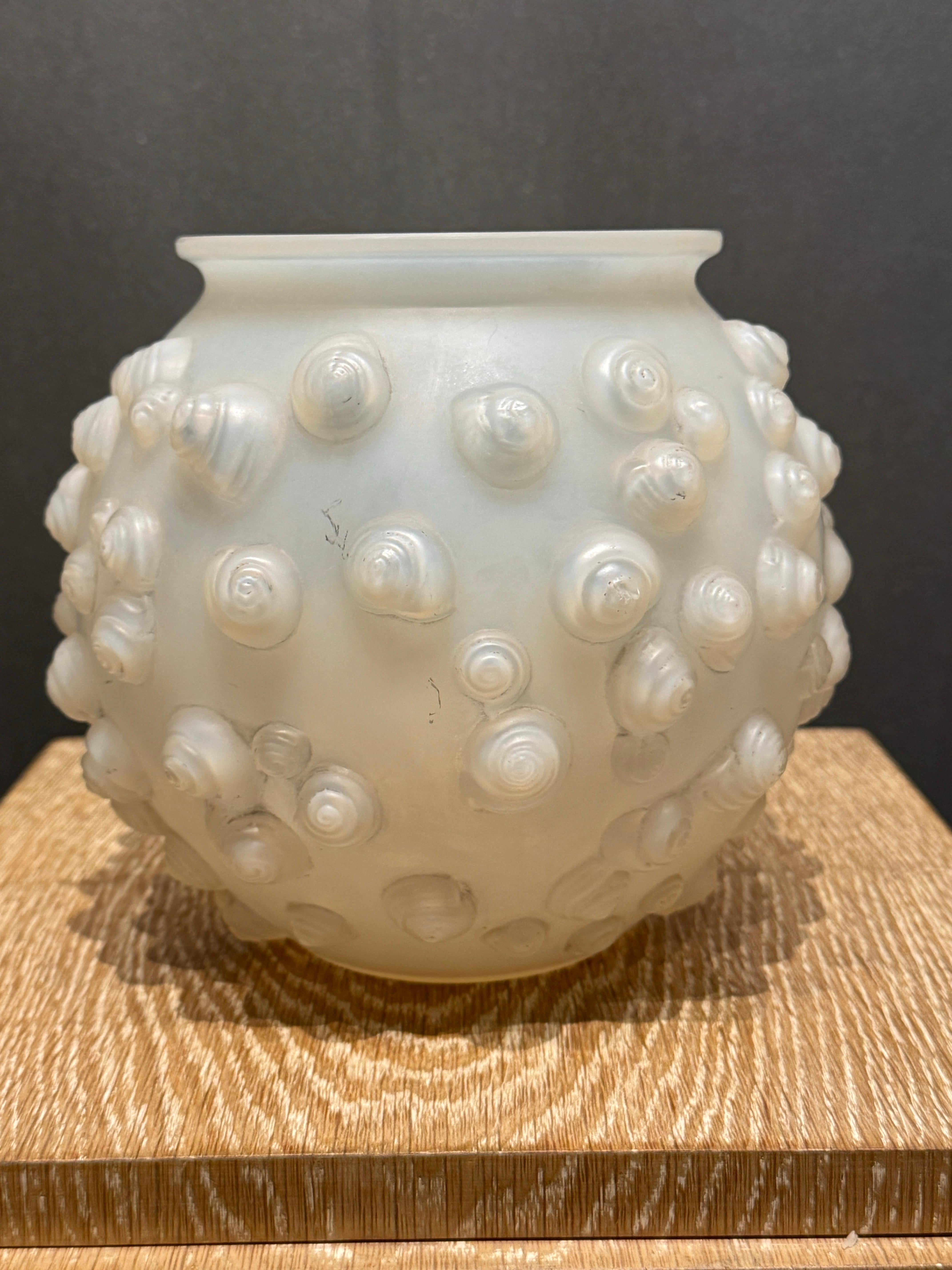 The Palissy vase is created in 1926 in white glass by R.Lalique.

This example is in opalescent glass and in excellent condition.

The vase is signed in hand written script letters .