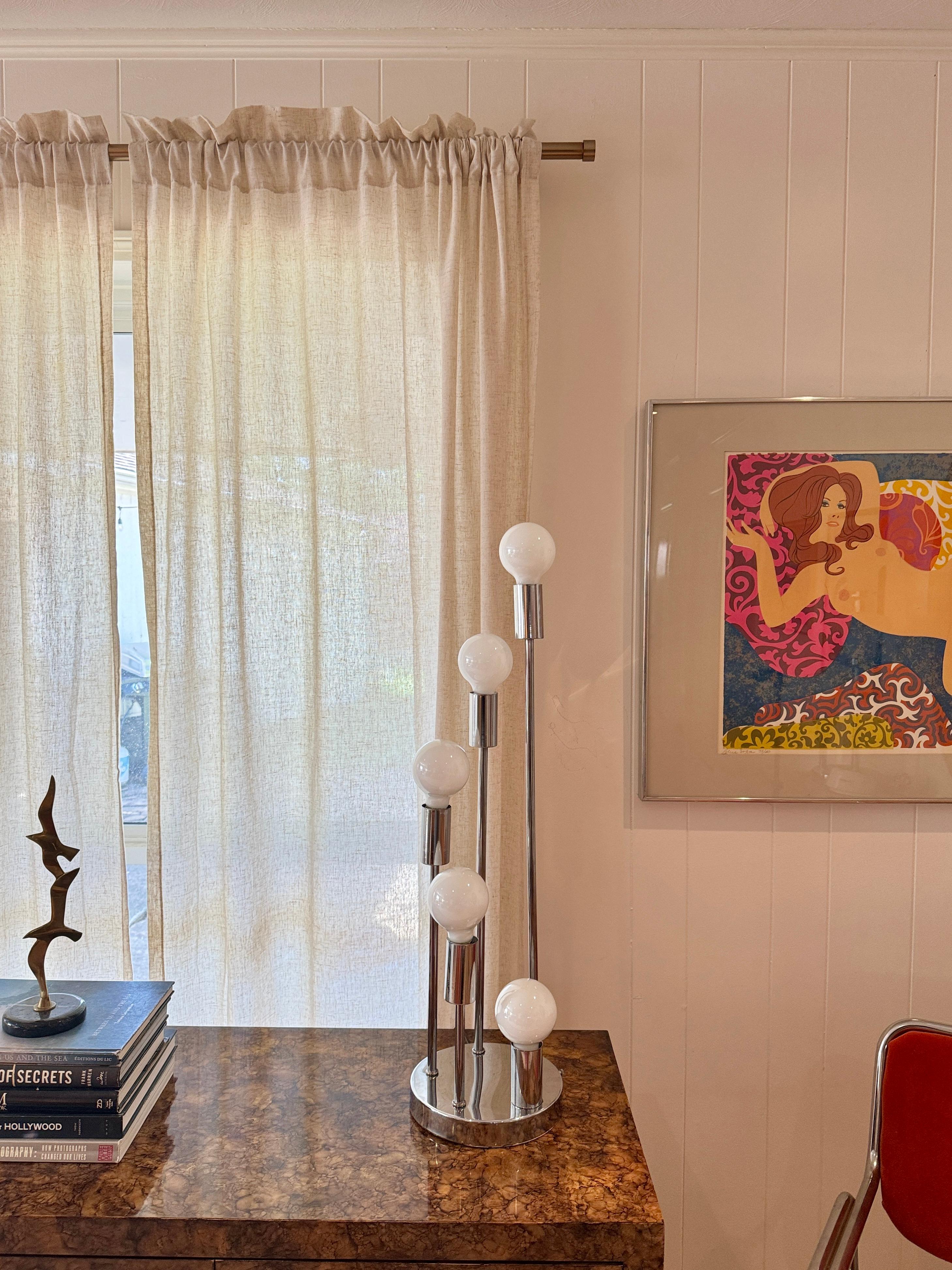 A Robert Sonneman Style waterfall table lamp, circa 1960s. Five globes descend in a spiral/waterfall formation. Lamp is controlled by a switch at the base. 3 way Switch controls, bottom two bulbs, the top three, or all 5 at once. Overall in good