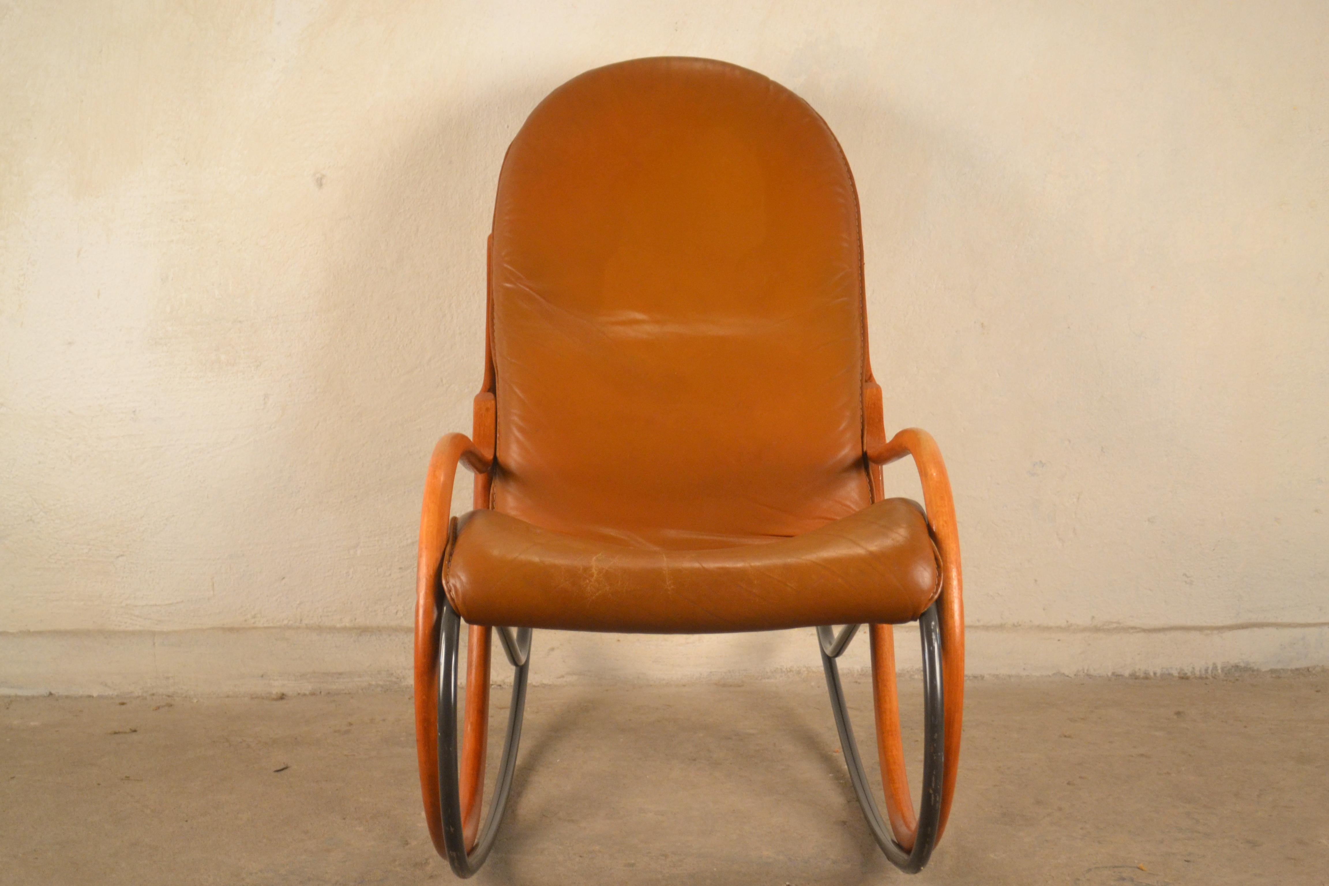 A rocking chair designed by Paul Tuttle, Strässle, Switzerland in the 1970s Fully original, without renovation. The chair uses the highest quality natural leather. There are visible traces of streaks on the back of the material. In general, the