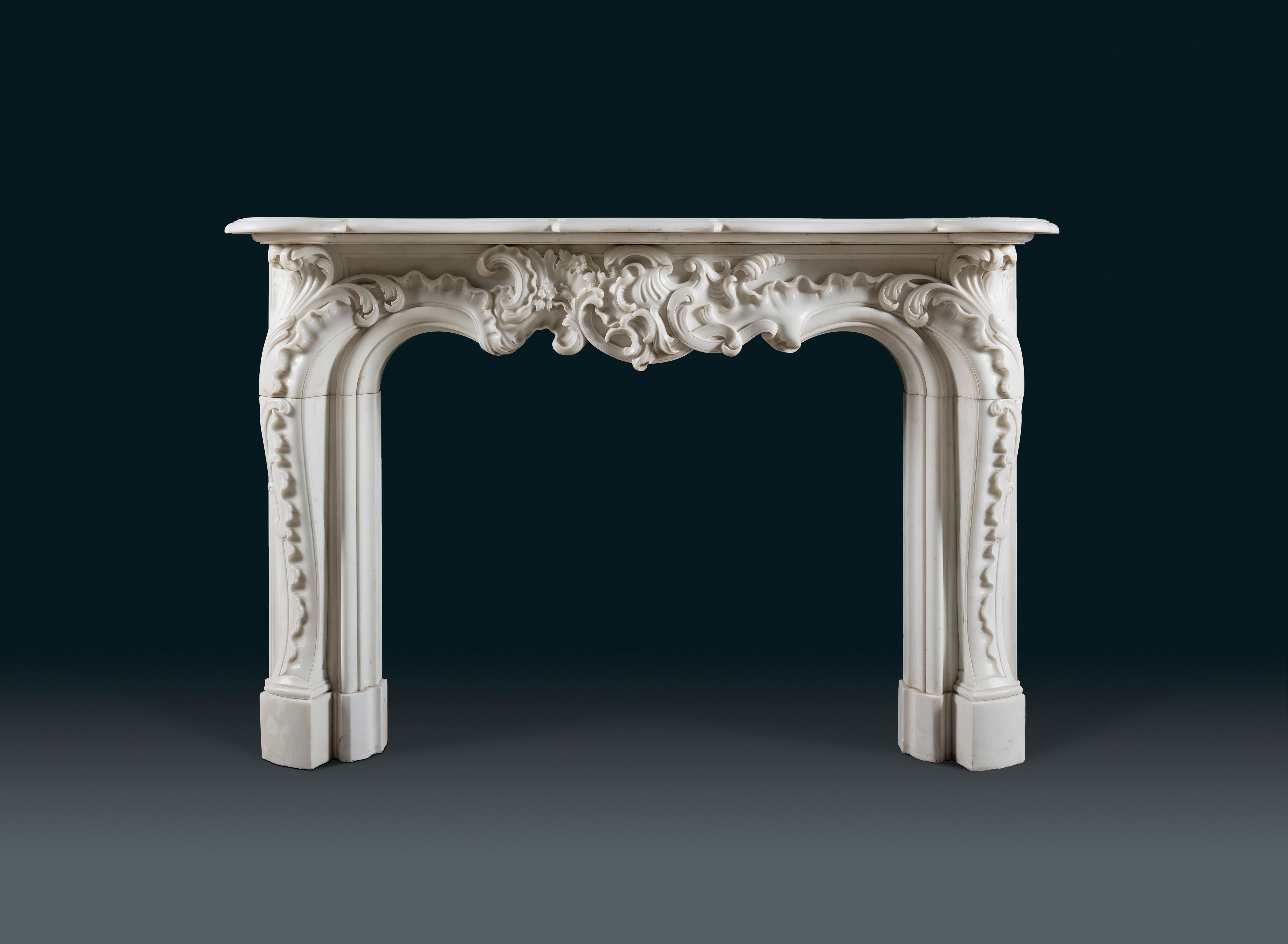 French A Rococo 19th century chimneypiece of very large scale in white statuary marble. For Sale
