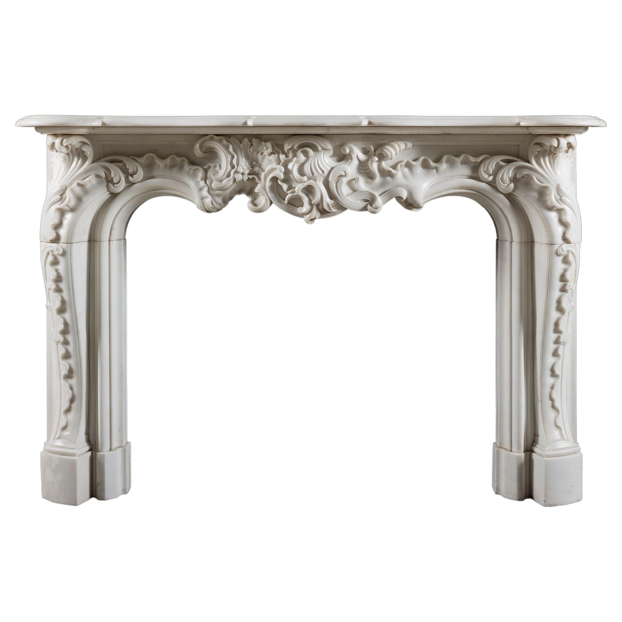 A Rococo 19th century chimneypiece of very large scale in white statuary marble.