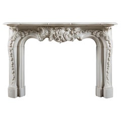 A Rococo 19th century chimneypiece of very large scale in white statuary marble.