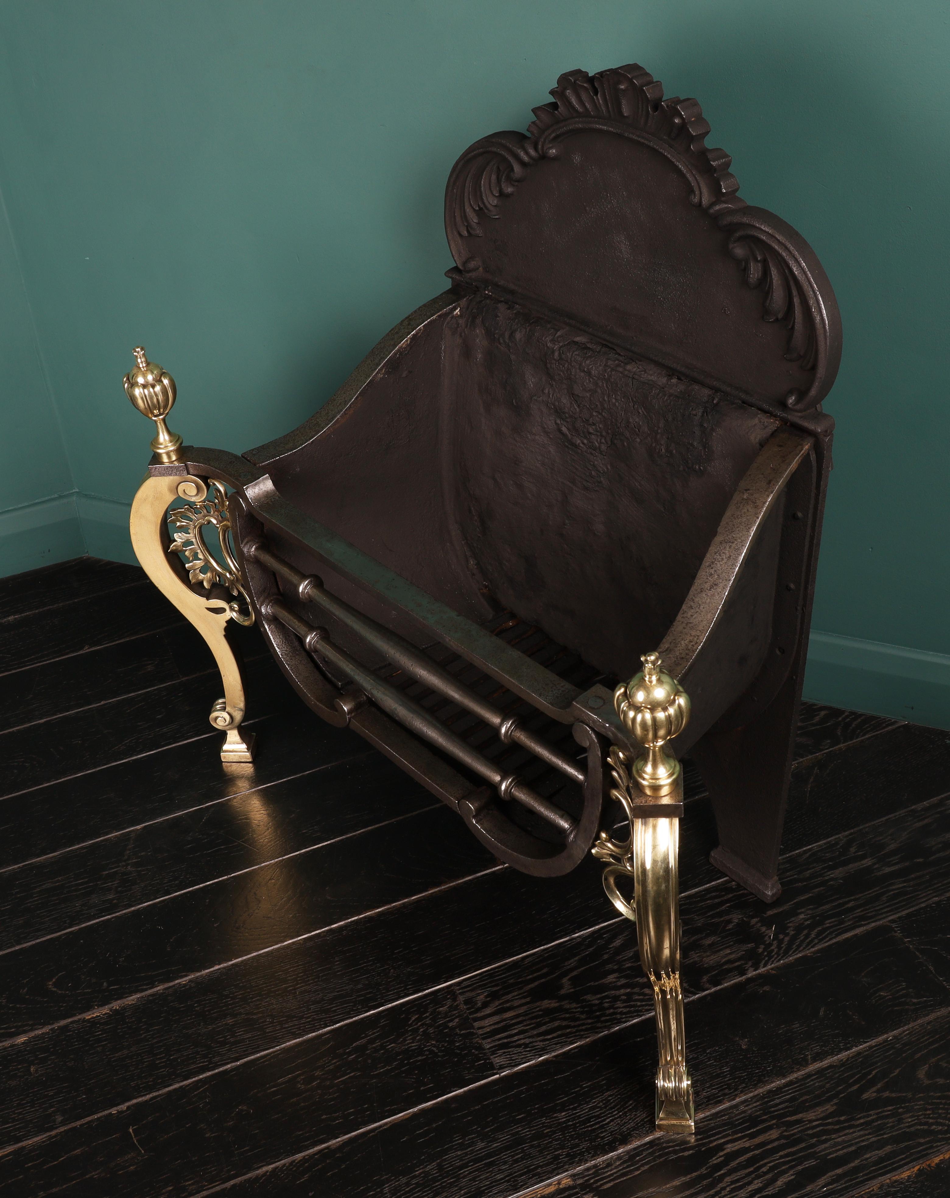 A Rococo brass and steel fireplace fire basket in the Chippendale manner. A well-made 19th century version of an earlier Chippendale design, by Thomas Elsley. The shaped polished steel fire bars set between brass scrolls and foliage with segmented
