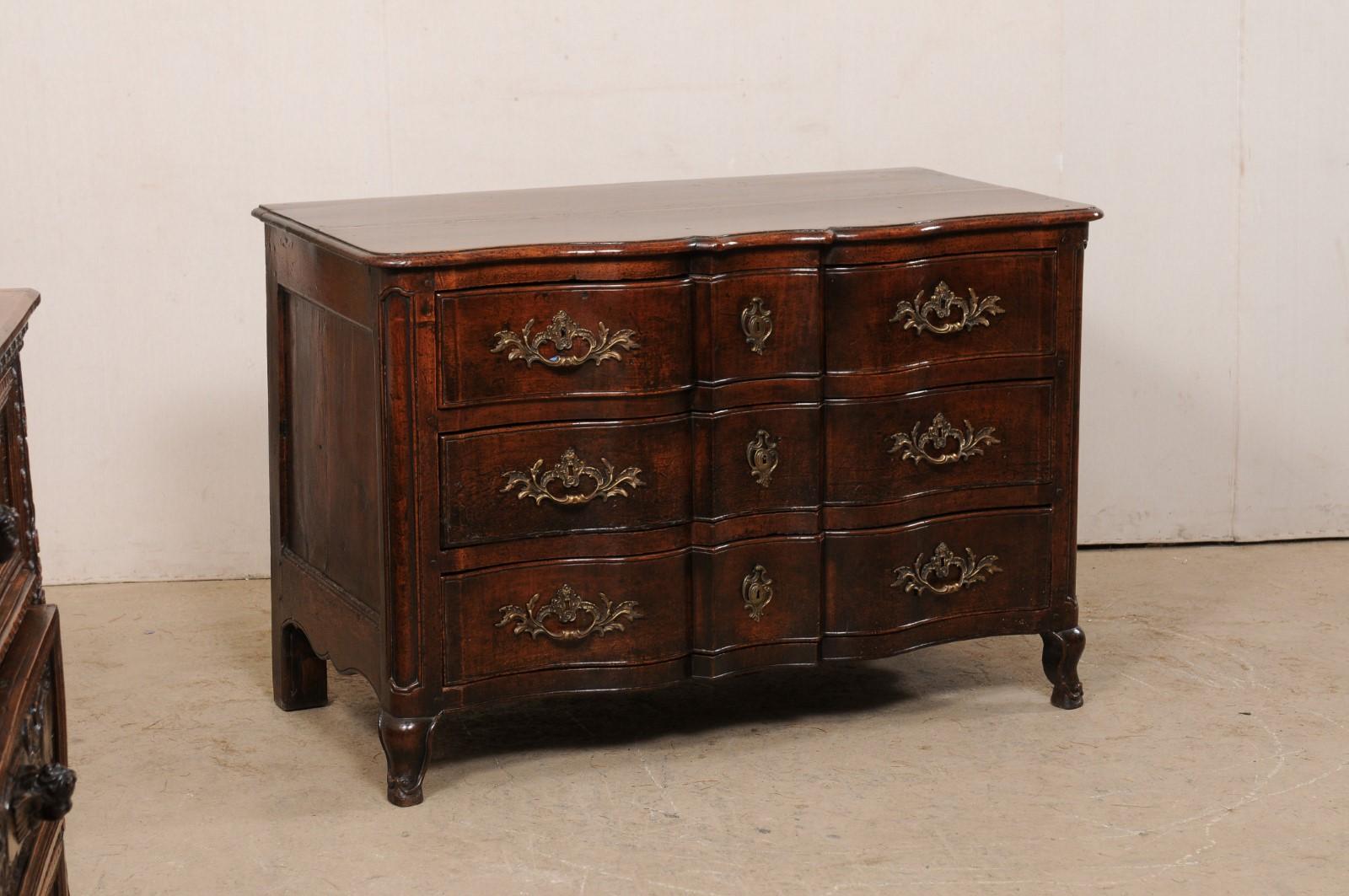 A French period rococo serpentine chest of drawers from the 18th century. This antique commode from France features a rectangular shaped top, with softly-rounded corners and serpentine front lines, which mimic the movement of the case beneath. The
