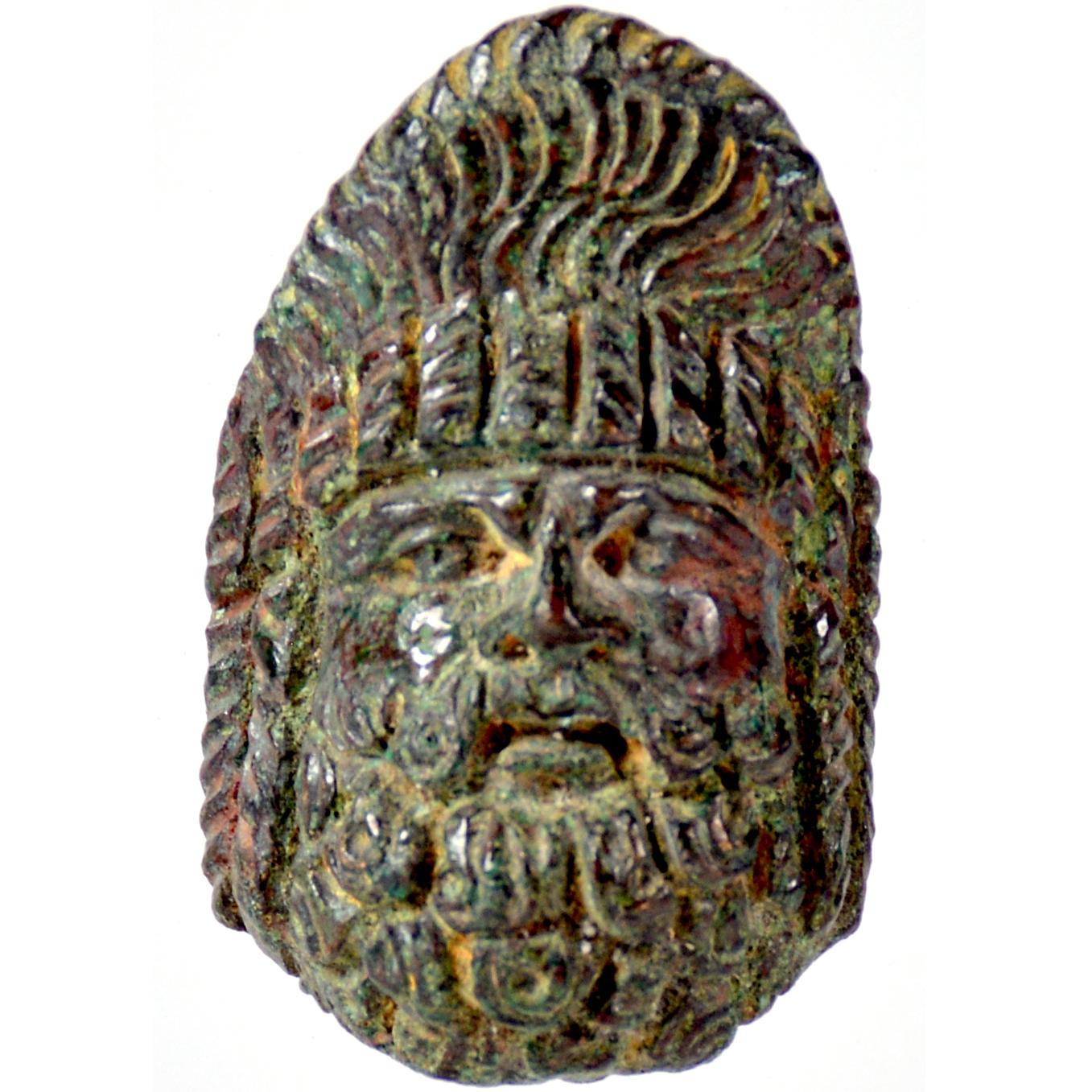 Mask of a bearded deity, short beard and hair braided in the characteristic high hairstyle, with layered ringlets on either side.

4 cm (h)

Green patina

Ex Canadian private property, Mr. M.M., collected 1960’s