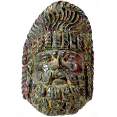 A Roman bronze applique in the shape of a theatre mask