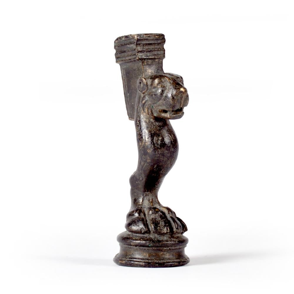 With square fitting, hollow at the top for attachment to furniture, one large paw on round base sprouting into lion’s head with visible teeth.

9,5 cm (h)

Ex German private property, J. Brewi, Saarland, collected 1980’s