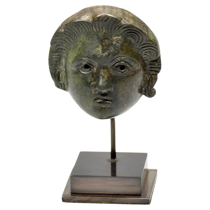 A Roman bronze head attachment of a youth For Sale