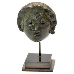 A Roman bronze head attachment of a youth