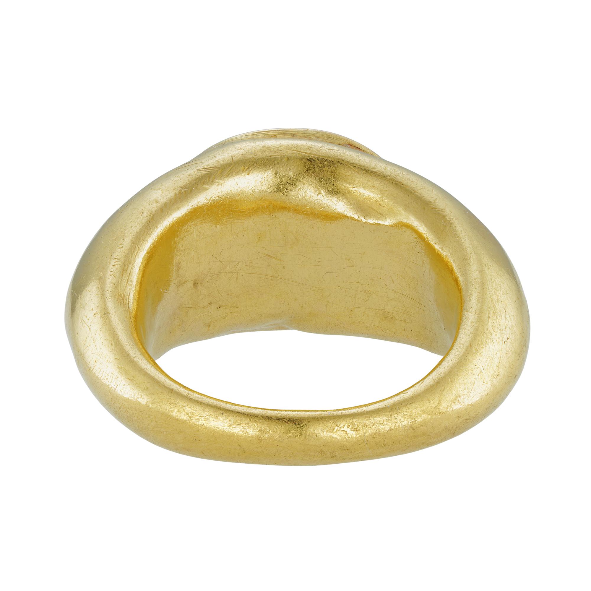 A Roman intaglio gold hardstone ring, the oval shaped rose-quartz measuring 1.4 x 1.1cm, deep engraved with the profile of an Emperor wearing a laurel wreath, possibly Nero, Roman-set in landscape position to a hollow yellow gold mount with closed