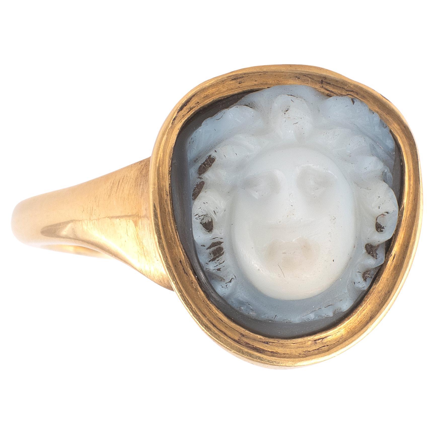 The stone agate onyx two layers of gray and blue, the head of Medusa is carved in high relief, with the face turning slightly to the left.

Dimension of the cameo: 1,2cm x 1,2 cm
Size: 7 1/4
Weight: 9,2gr.