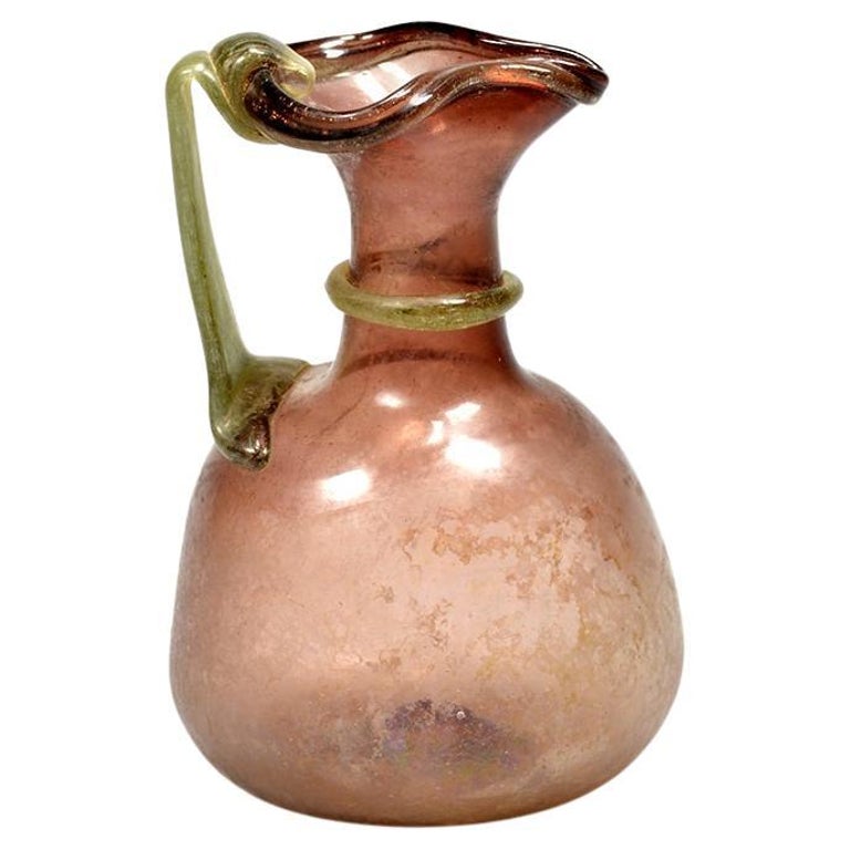 https://a.1stdibscdn.com/a-roman-purple-glass-jug-for-sale/f_65662/f_365736221697089180956/f_36573622_1697089181166_bg_processed.jpg?width=768