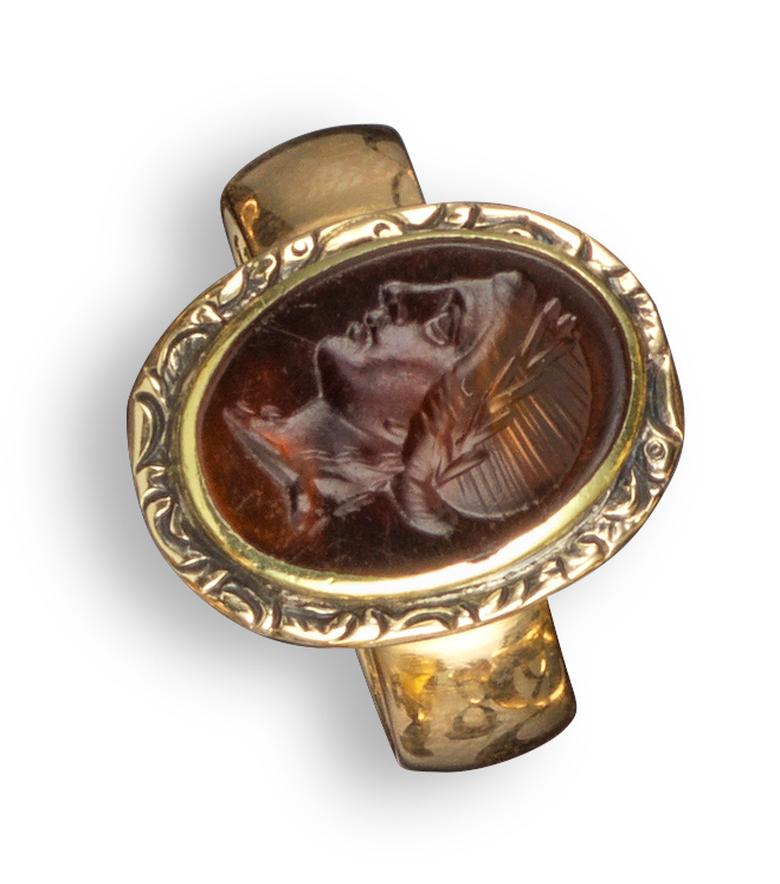 Apollo's head in profile and with laurels, in a 19th century composite gold mount with inner inscription dated 1886, intaglio 1.2cm high, ring size 5 1/2
For an impression of a similar intaglio, see J. Boardman, C.Wagner, D.Scarisbrick, E.