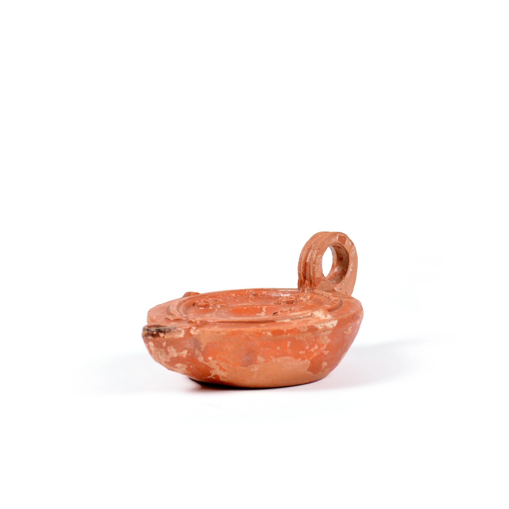 18th Century and Earlier A Roman terracotta red slip ware oil lamp with theatre masks For Sale