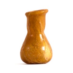A Roman yellow glass unguentarium