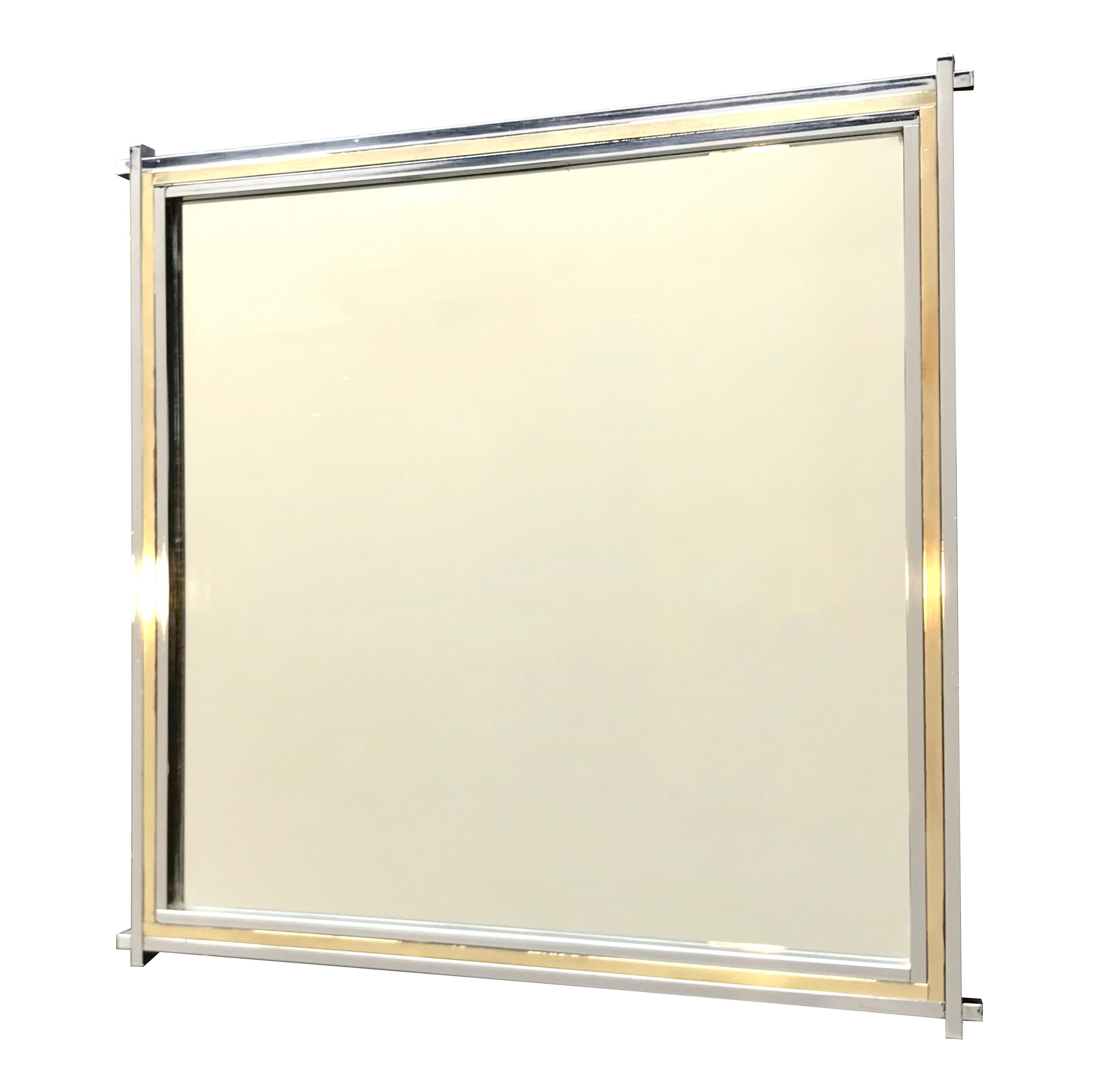 A Romeo Rega square mirror with brass and chrome frame with extending corner detail.