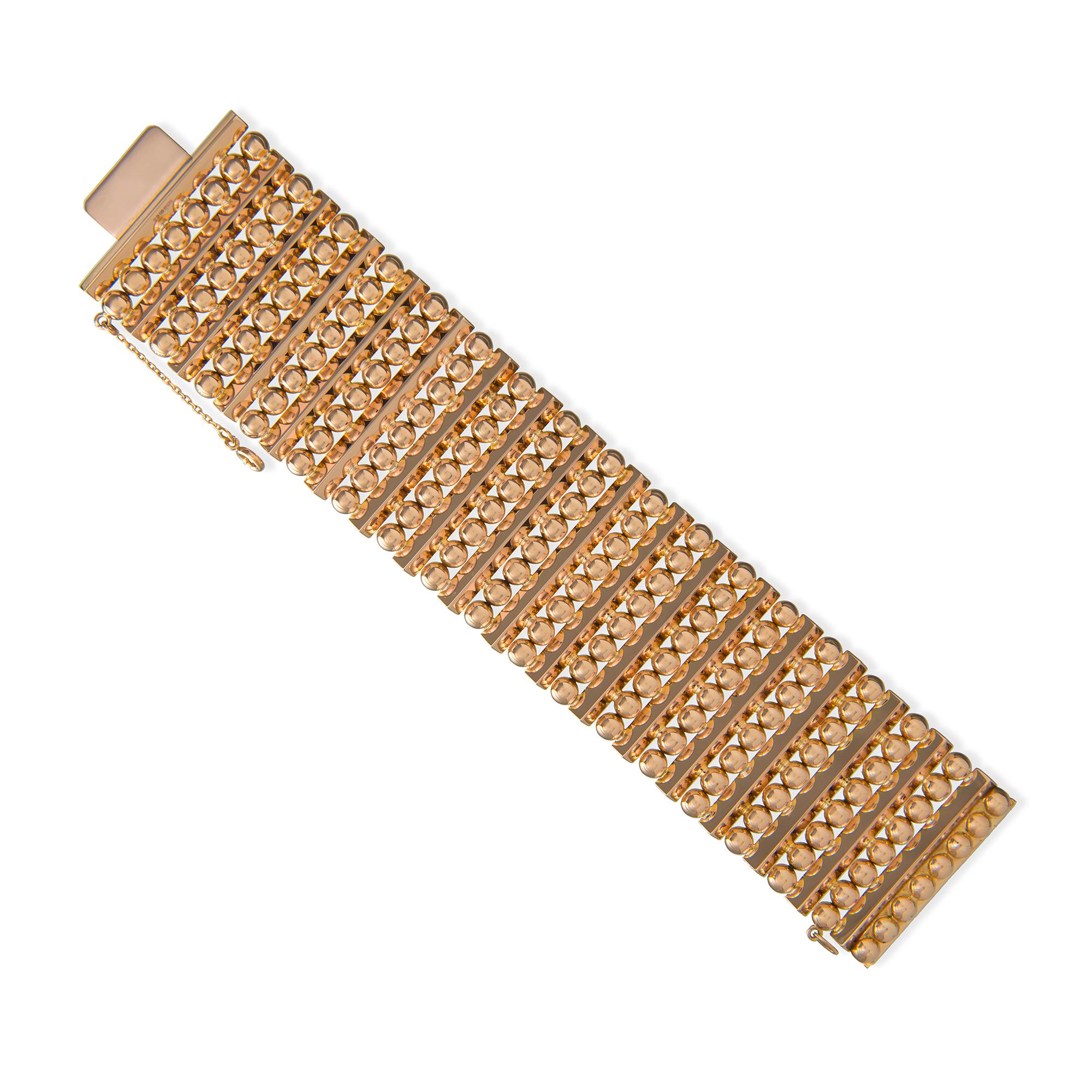 A rose gold wide flexible cuff bracelet, the bracelet consisting of 18 rectangular bars linked together with ball-shaped hinges, to a push clasp and safety chain, bearing gold hallmark for 800/1000, Porto, 1938, later hallmarked 18ct gold, London,