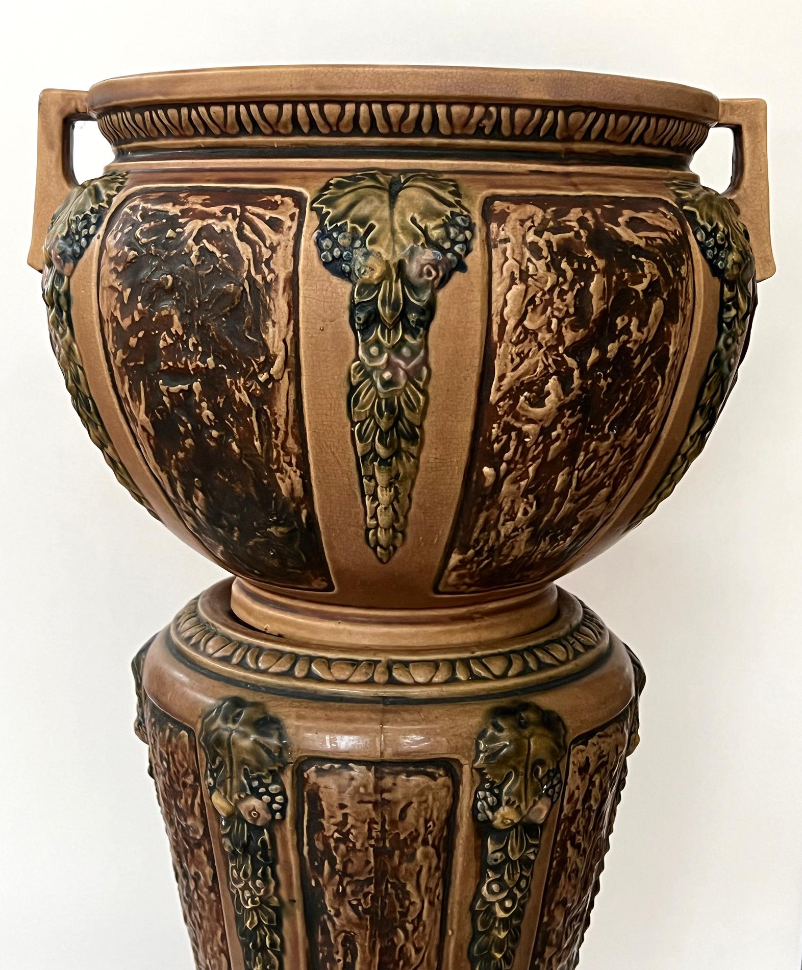 this Roseville jardiniere on pedestal in the rare Florentine Pattern manufactured from 1923-1926, featuring a bulbous double-handled urn resting on a tapering pedestal ending on a splayed foot; adorned overall with egg-and-dart perimeter bands and