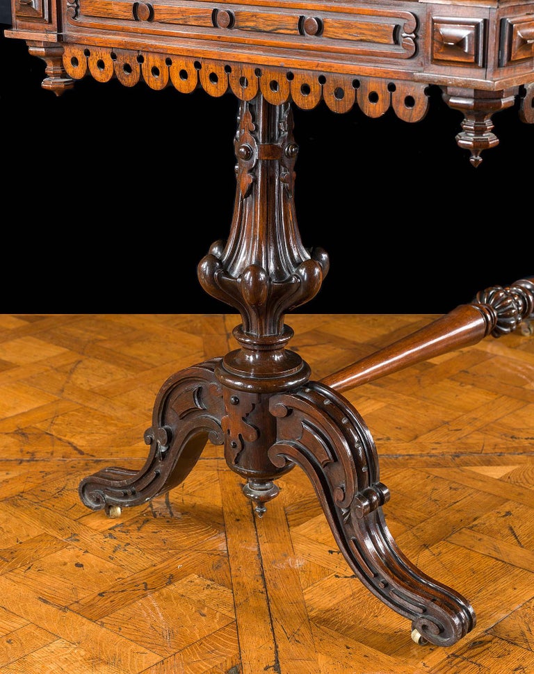 A fine, early 19th century rosewood library table in the manner of the architect and designer Richard Bridgens (1785-1846). The finely figured top with a moulded edge above a carved scroll, baton and disc frieze is edged with rows of pierced
