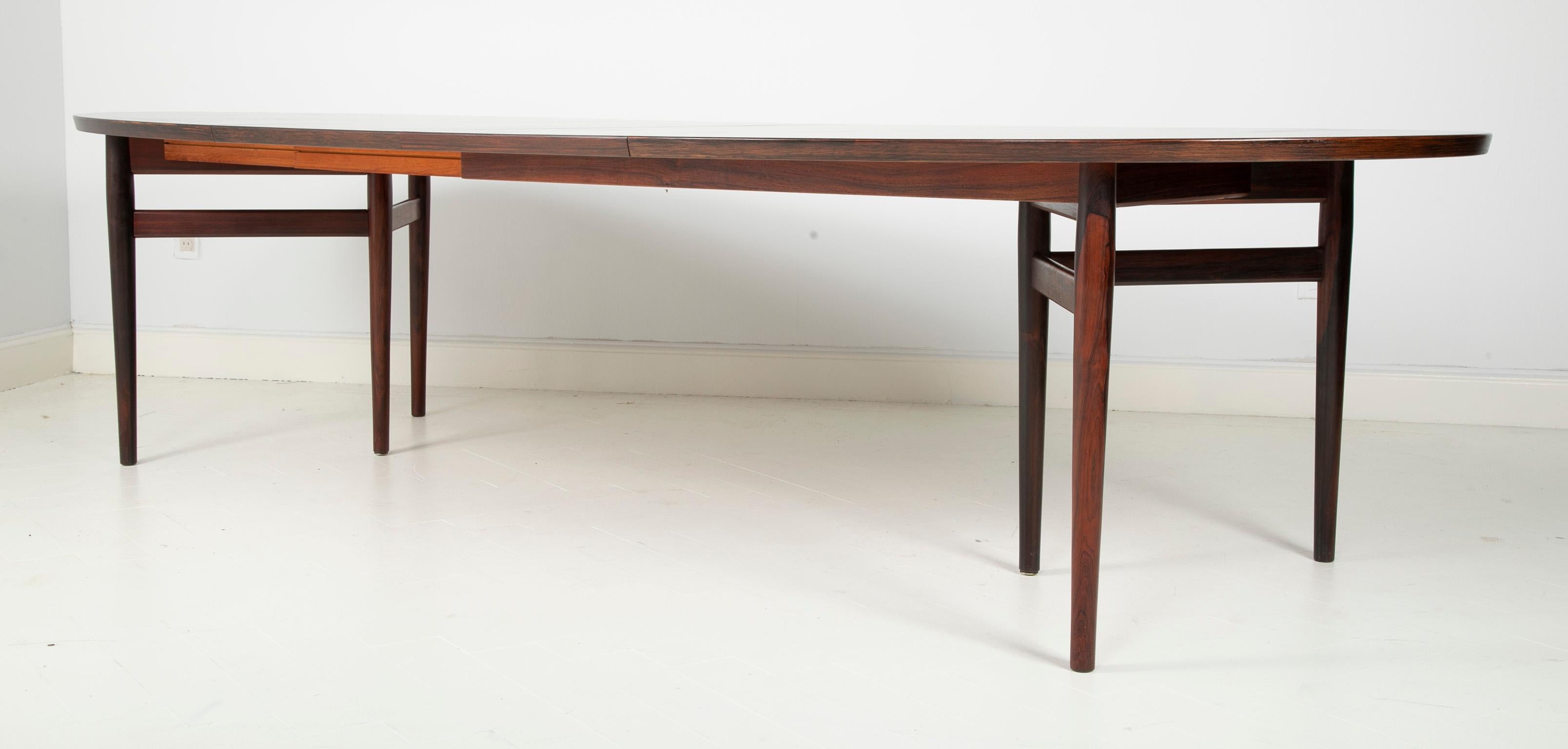 A Arne Vodder designed rosewood oval dining table with two additional leaves. Produced by Sibast Furniture in Denmark, circa 1965.

Measures: Total without leaves 78 inches
Total with leaves 118.5 inches
There are 2 x 19.5 inch leaves.