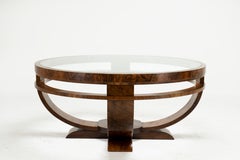 A Round Art Deco Coffee Table With Glass Top