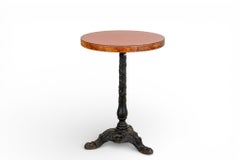A Round Bistro Table With an Iron Base