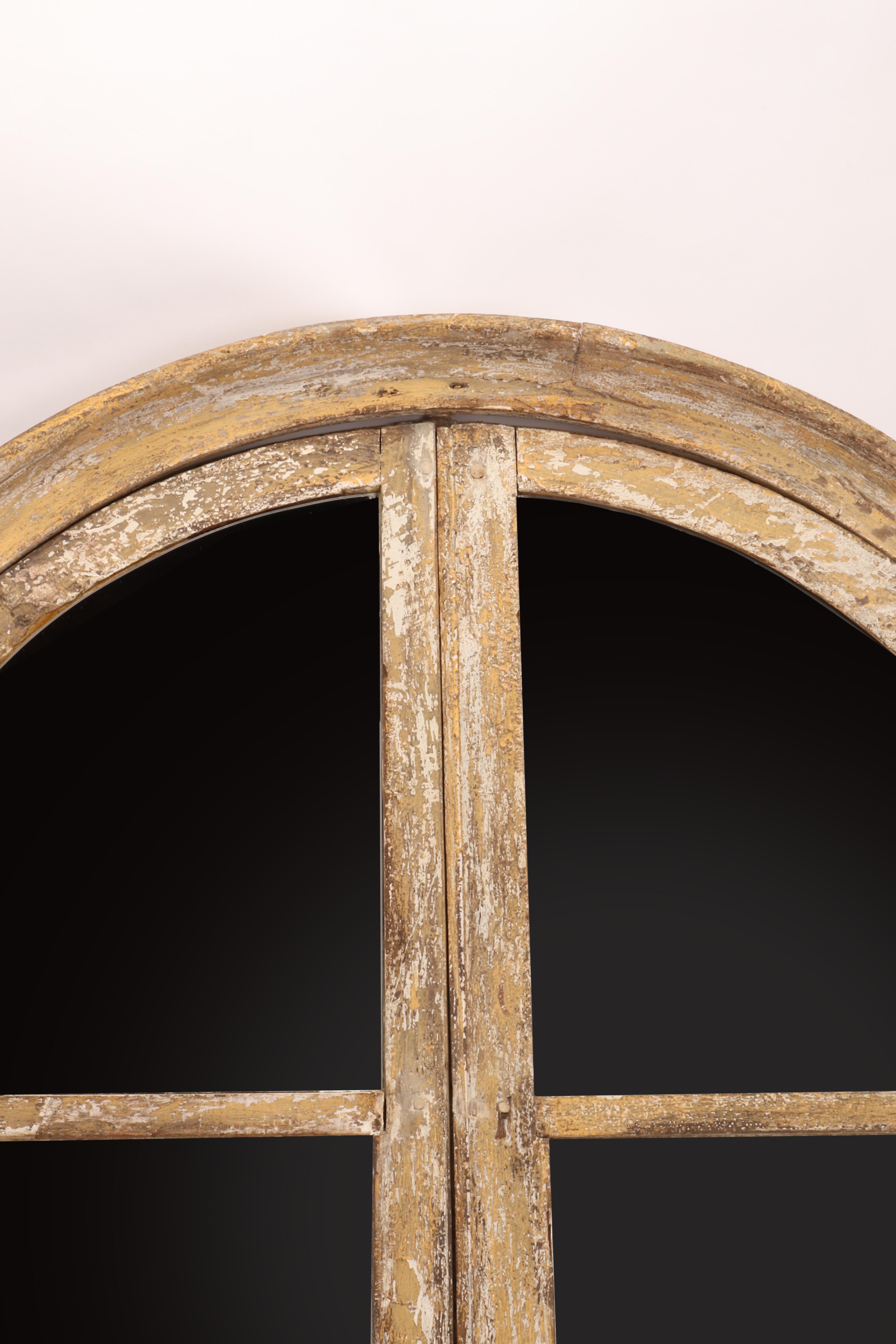 A fine example of reinterpretation and realization of an antique 18th century architectural element. A wooden round window of an old house, with original hinges, have been reused as a mirror. The frame is made out of painted wood, white color,