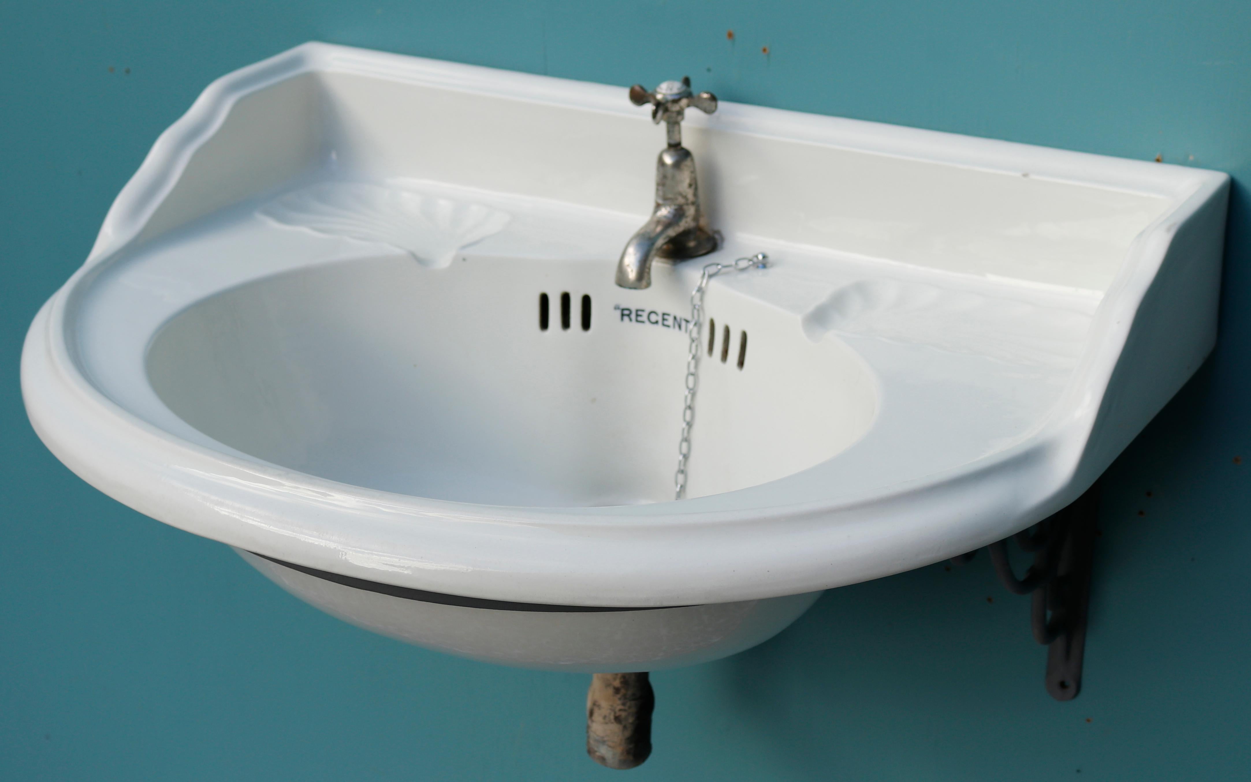 Antique rounded porcelain sink with bracket. This sink was manufactured by Morrison Ingram & Co. It was reclaimed from a church in Glasgow along with two other matching basins. All three are in very good condition, having ben removed and stored in