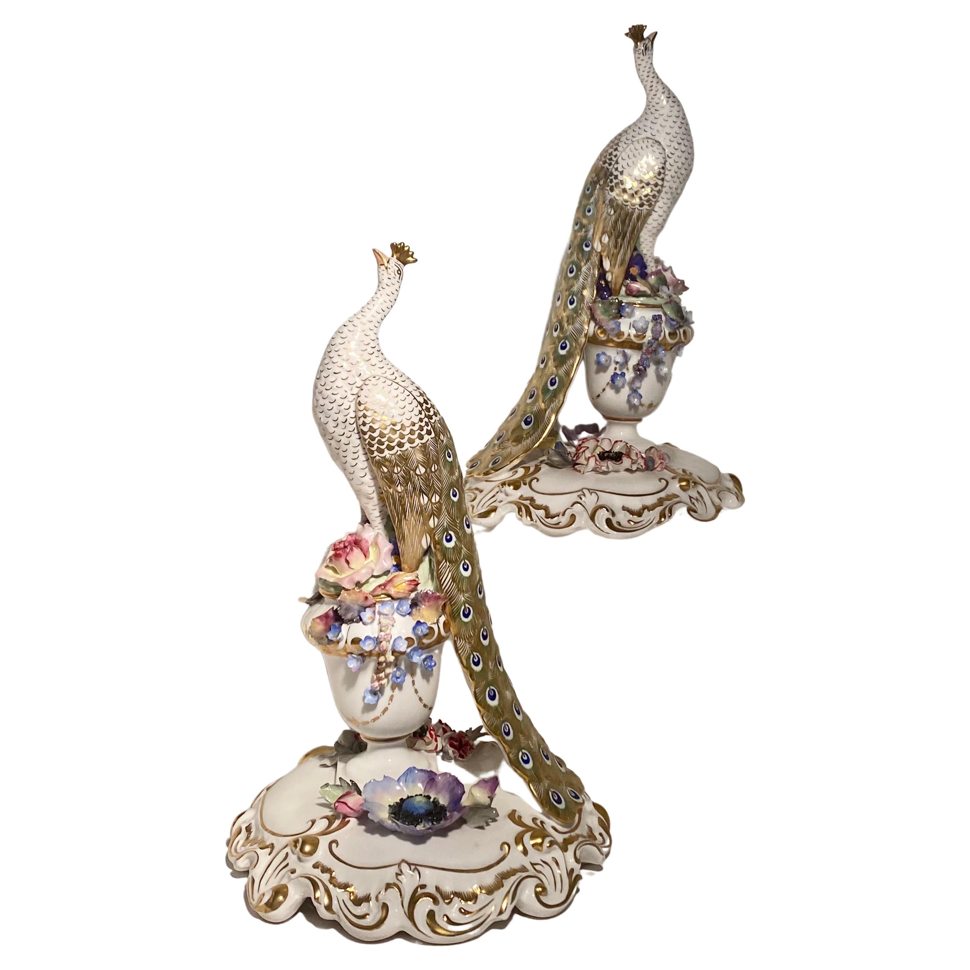 Here is a stunningly lovely pair of peacocks made by Royal. Crown Derby with the marks indicating they were made in the 1960s. Each bird is entirely handmade and bear the artists named on the bases. They are so delicate. The birds on pedestal is