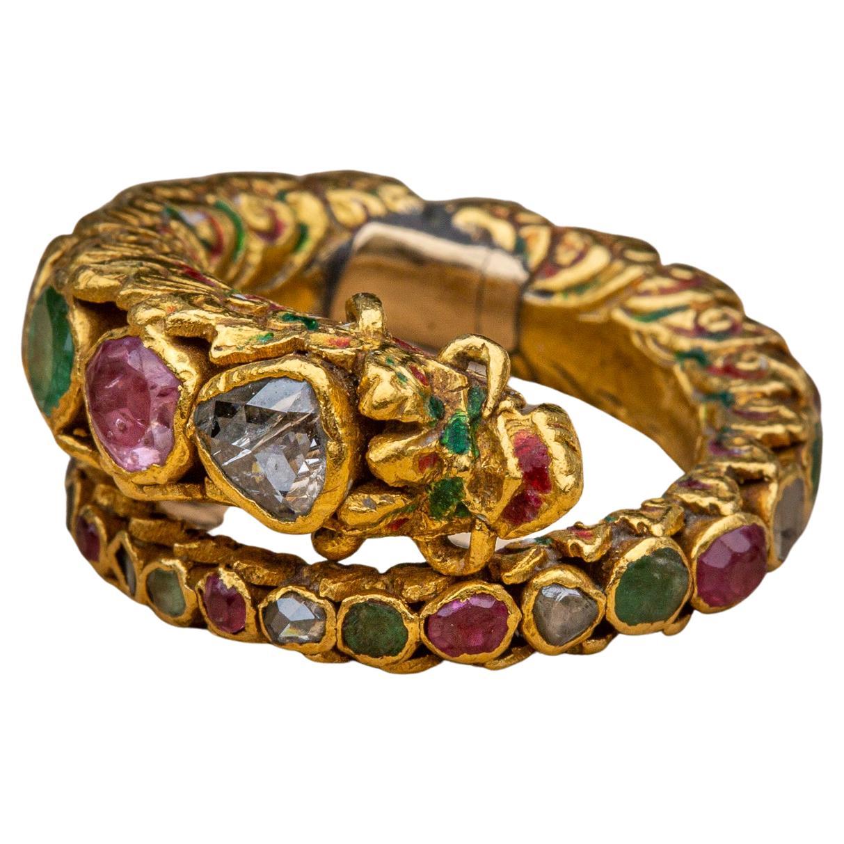 A late 18th century gem-set royal gold ceremonial Naga ring made in Siam during the Rattanakosin period. The ring takes the form of a mythical serpent known as a ‘Naga’. 

Prevalent throughout Buddhism and Southeast Asian art, the Naga is a mythical