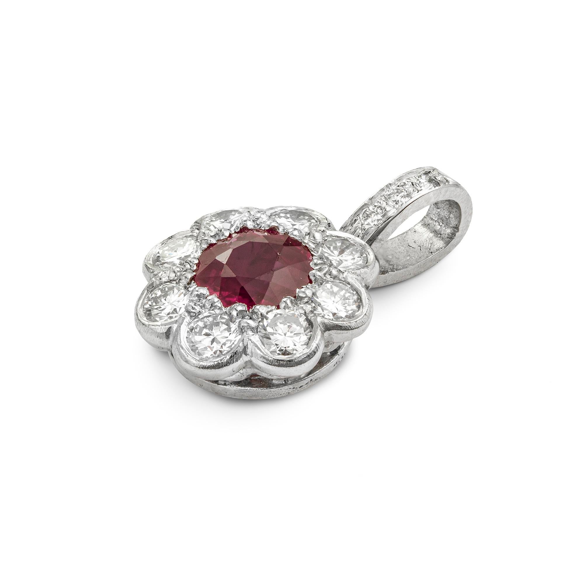 A ruby and diamond cluster pendant, the centre a round brilliant-cut ruby, to weigh 0.53ct, surrounded by a border of round brilliant-cut diamonds, to weigh 0.3ct, all millegrain set in platinum, suspended from a diamond set loop, hallmarked 950