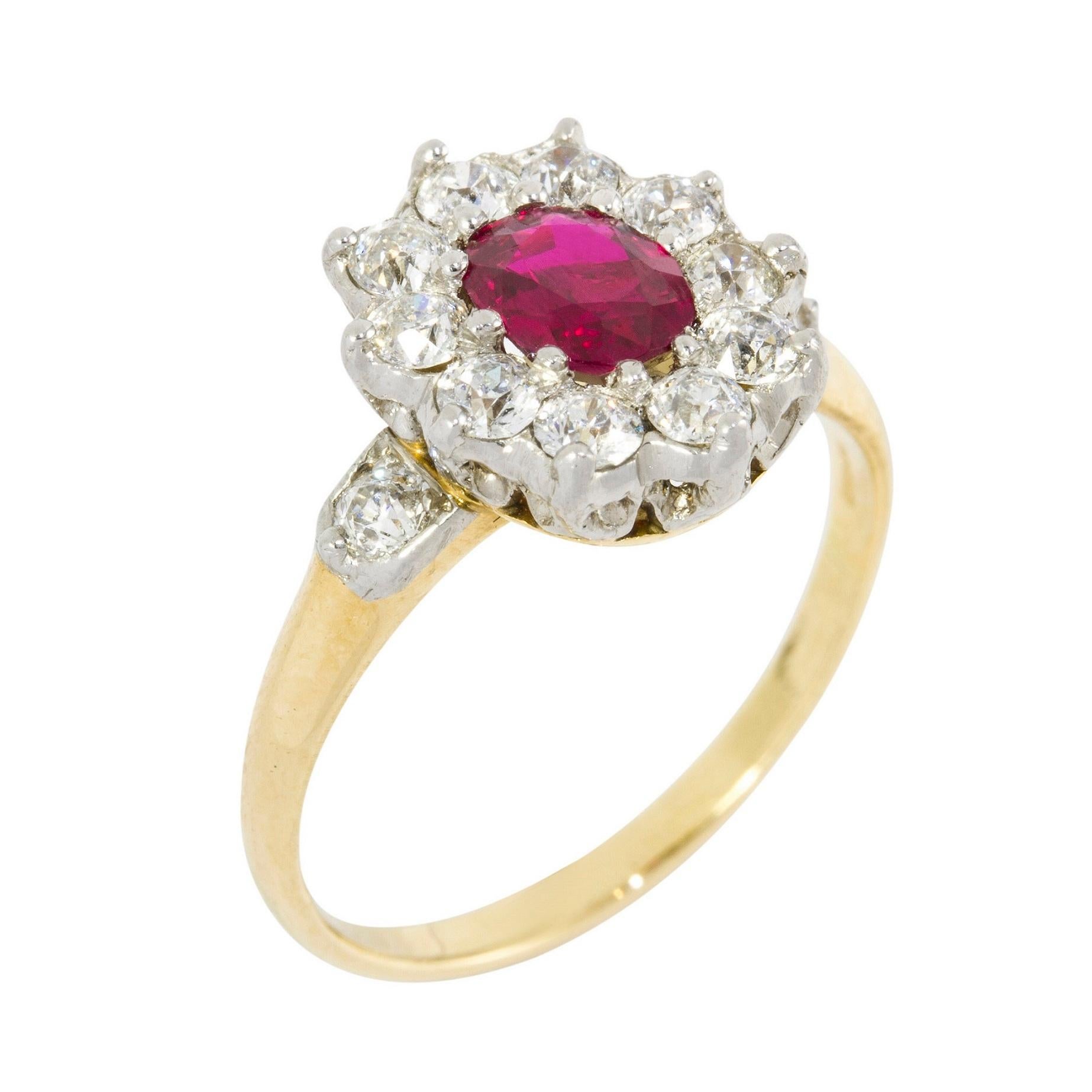 A ruby and diamond cluster ring, the oval faceted Burma ruby weighing 0.66 carats, Gem-A certificate, set to the centre of an old brilliant-cut diamond-set cluster, all set in white to a yellow gold mount with an old brilliant-cut diamond set on