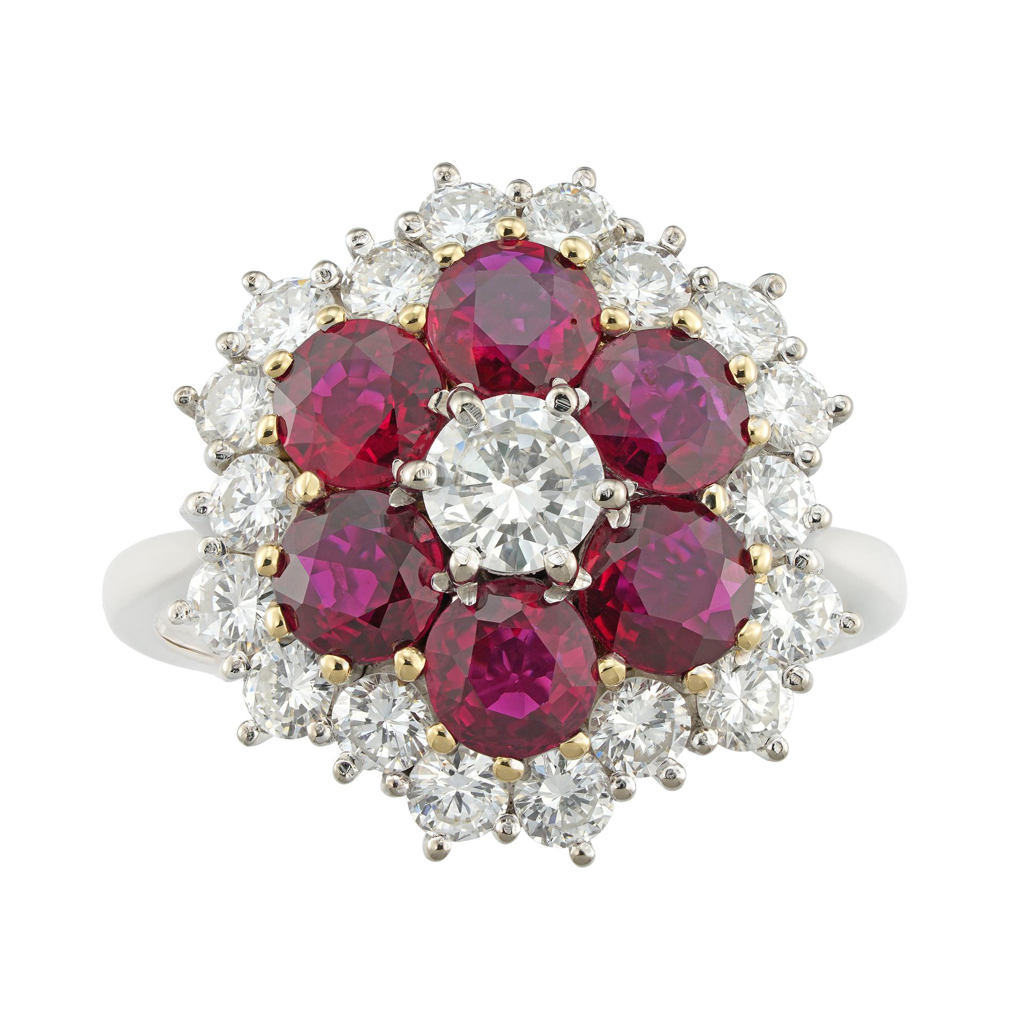 A ruby and diamond cluster ring, to the centre a round brilliant-cut diamond estimated to weigh 0.4 carats, surrounded by six round faceted rubies estimated to weigh 2.75 carats in total, accompanied by GCS Report stating to be of Thai origin with