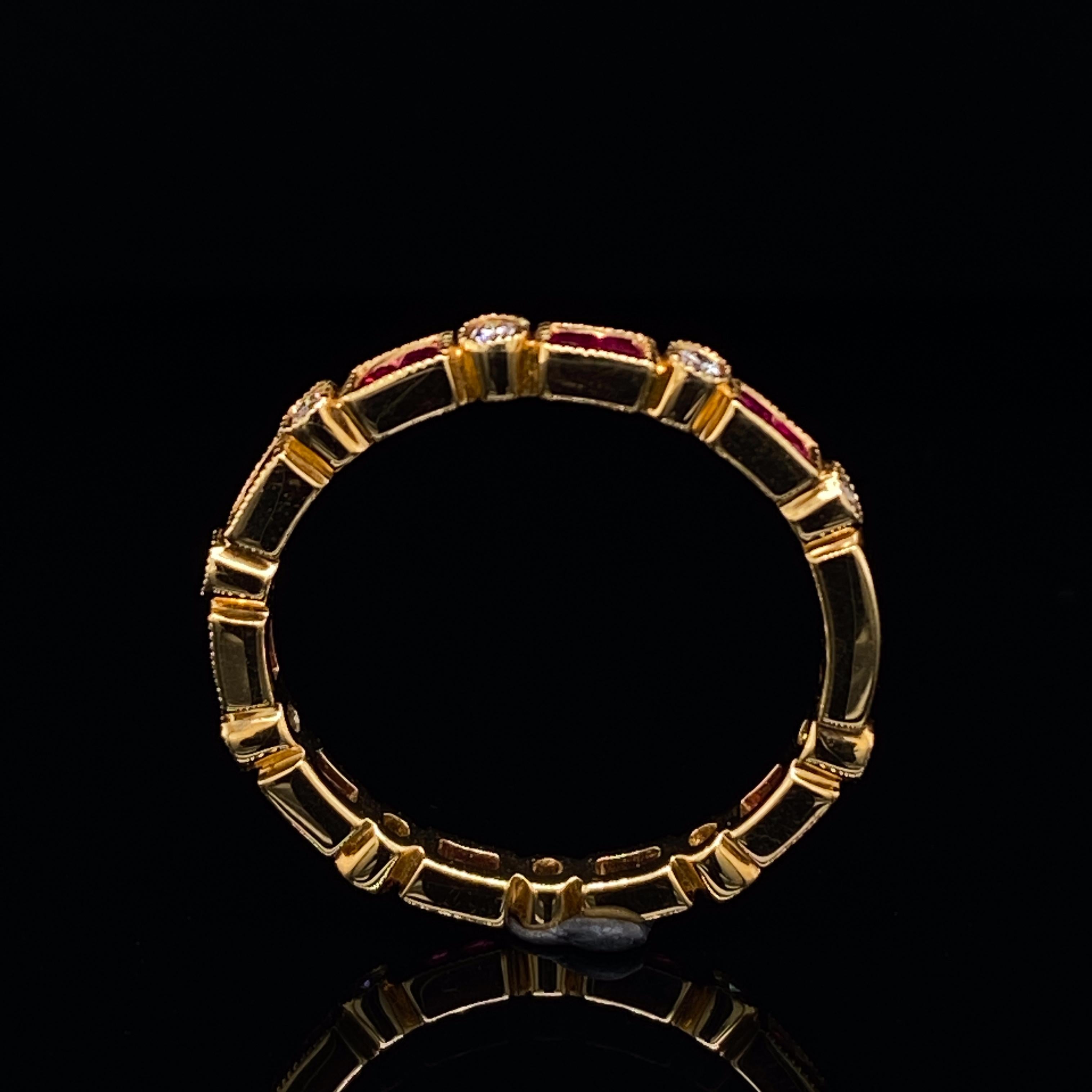 A ruby and diamond eternity ring in 18 karat yellow gold.

This ring is comprised of alternating pairs of step cut rubies and single round brilliant cut diamonds, all individually grain set in bezel mounts.

This ring is beautiful on account of its