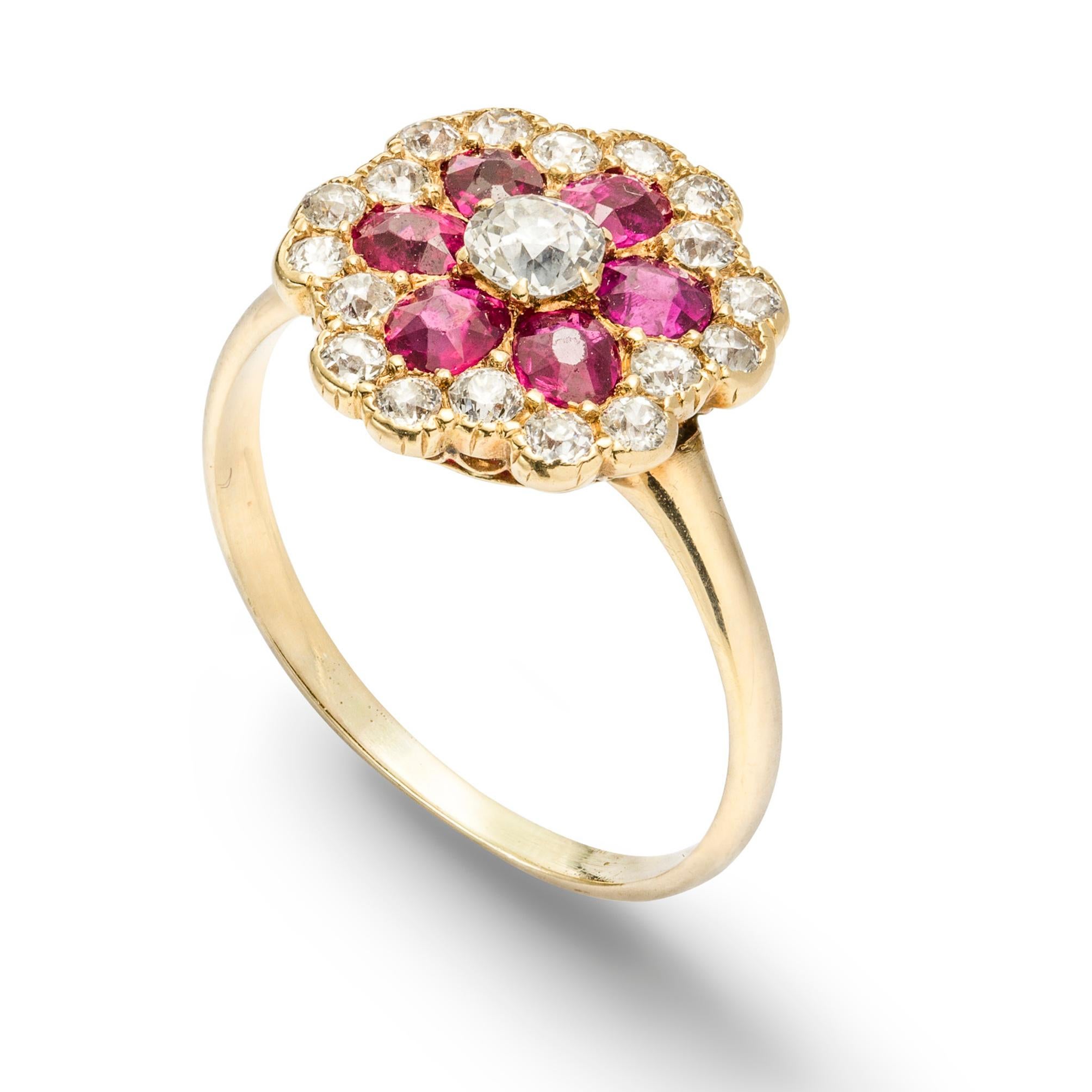 A ruby and diamond floral cluster ring, the central round brilliant-cut diamond, estimated to weigh 0.15 carats, surrounded by six oval faceted rubies, estimated to weigh a total of 0.6 carats, to a border of round brilliant-cut diamonds, estimated