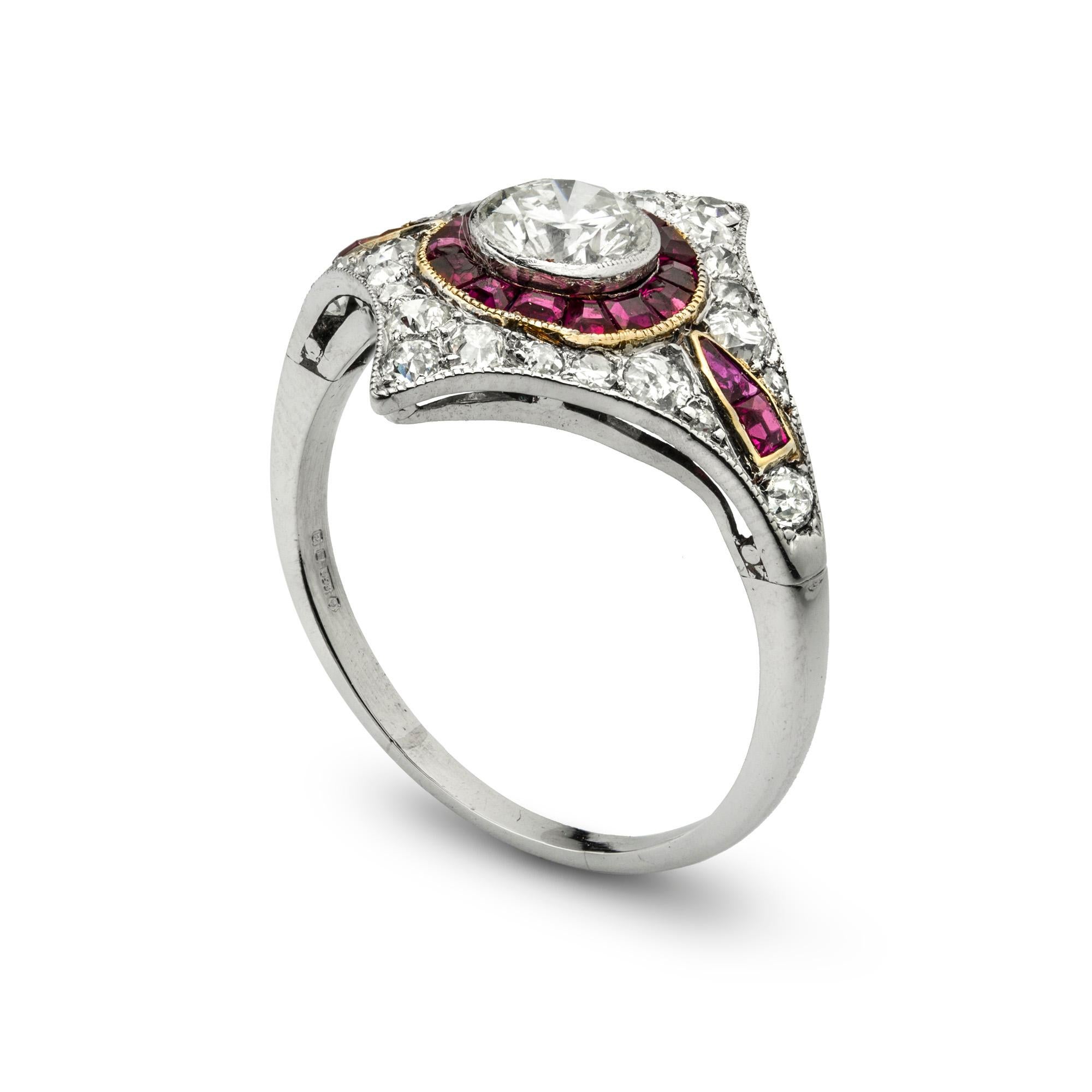 A ruby and diamond ring, the central round brilliant-cut diamond estimated to weigh 0.55 carats millegrain-set within a circle of calibré-cut rubies to a kite shape surround of pave-set old-cut diamonds estimated to weigh a further total of 0.6