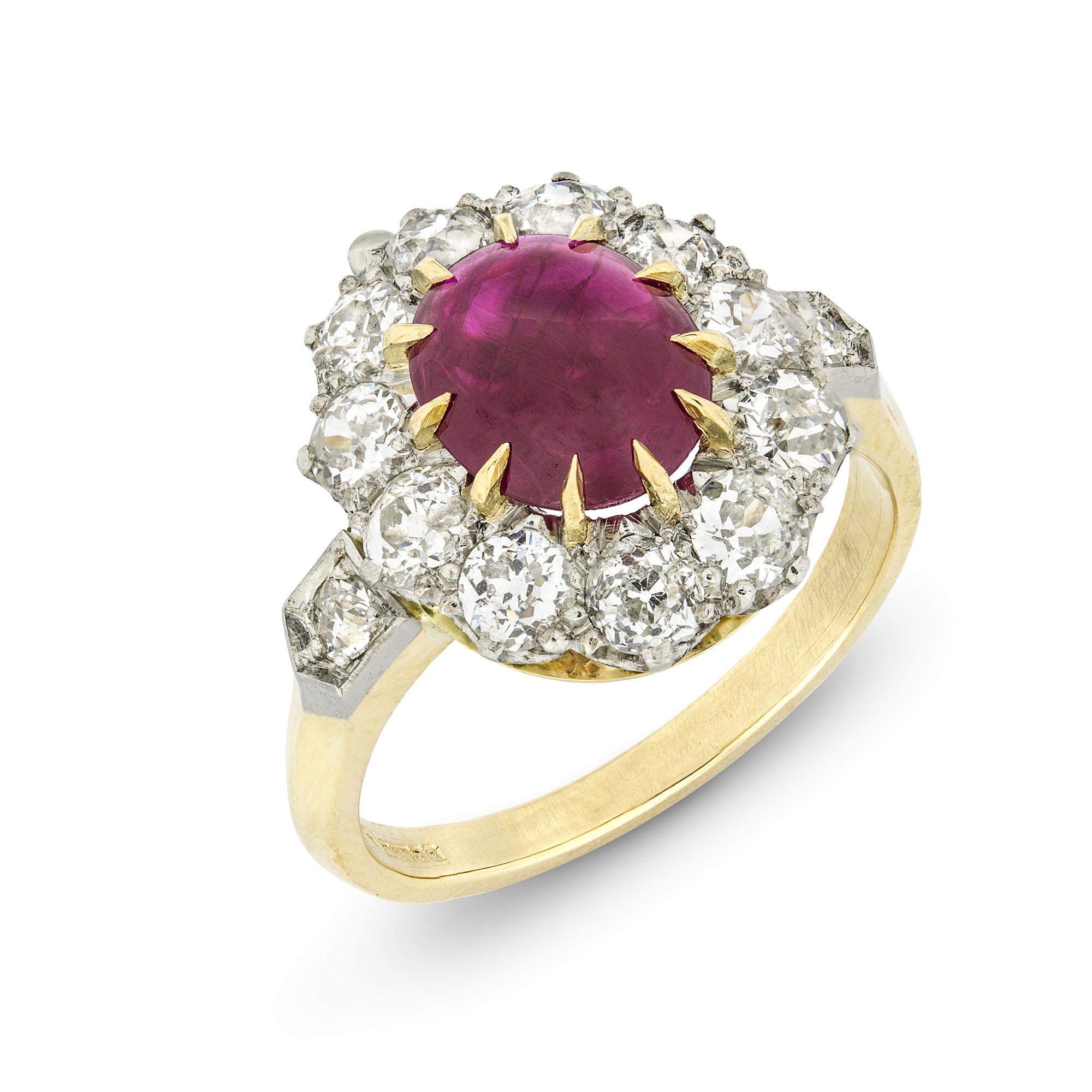 A ruby cabochon and diamond cluster ring, the central oval cabochon-cut ruby weighing 1.86 carats, to a yellow claw setting surrounded by eleven old brilliant-cut diamonds weighing a total of 1.4 carats, all claw set in platinum to a gold mount with